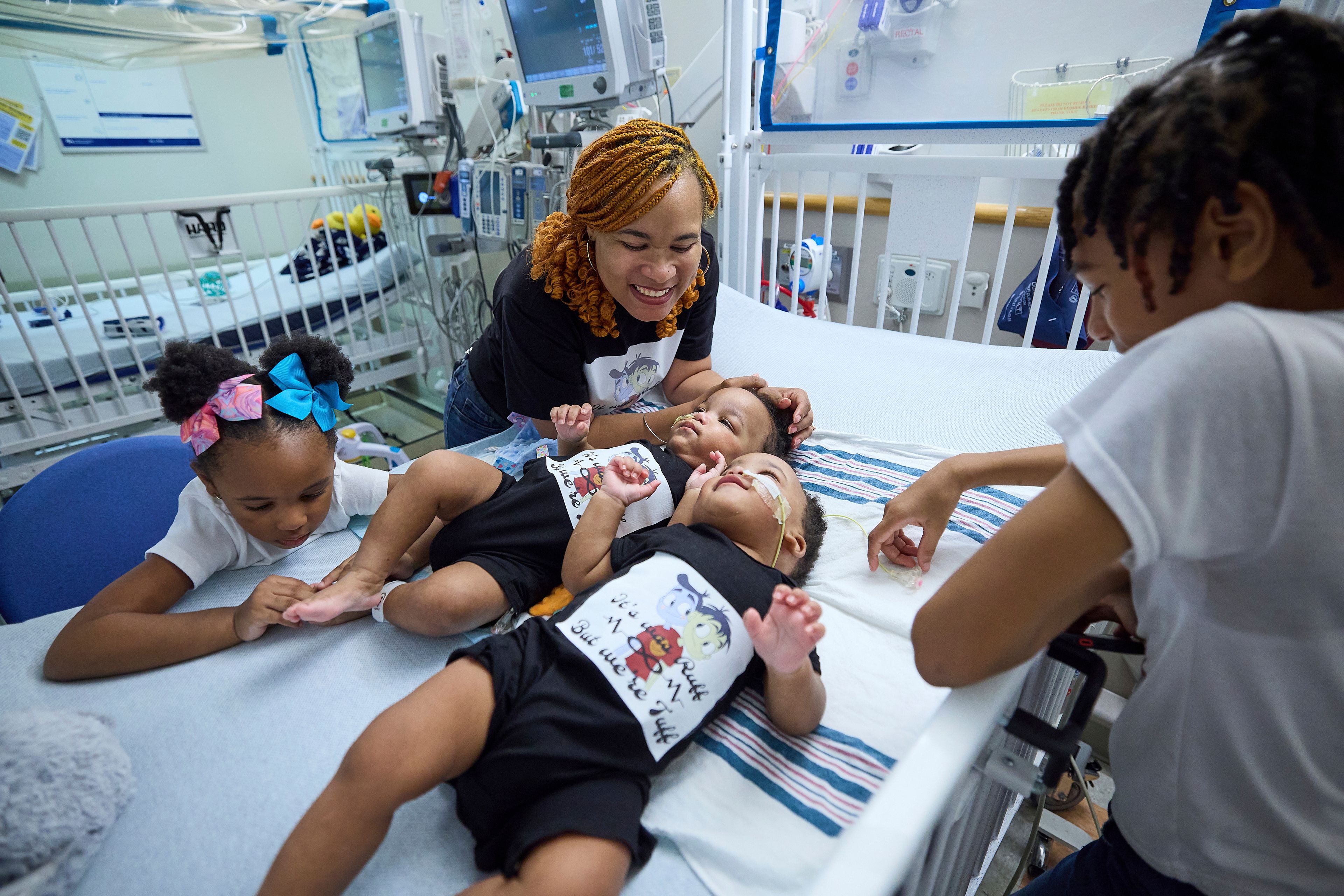 This undated photo provided by the Children’s Hospital of Philadelphia shows previously conjoined twins, Amari and Javar Ruffin, surrounded by family after separation surgery at the Children’s Hospital of Philadelphia. (Ed Cunicelli/Children’s Hospital of Philadelphia via AP)