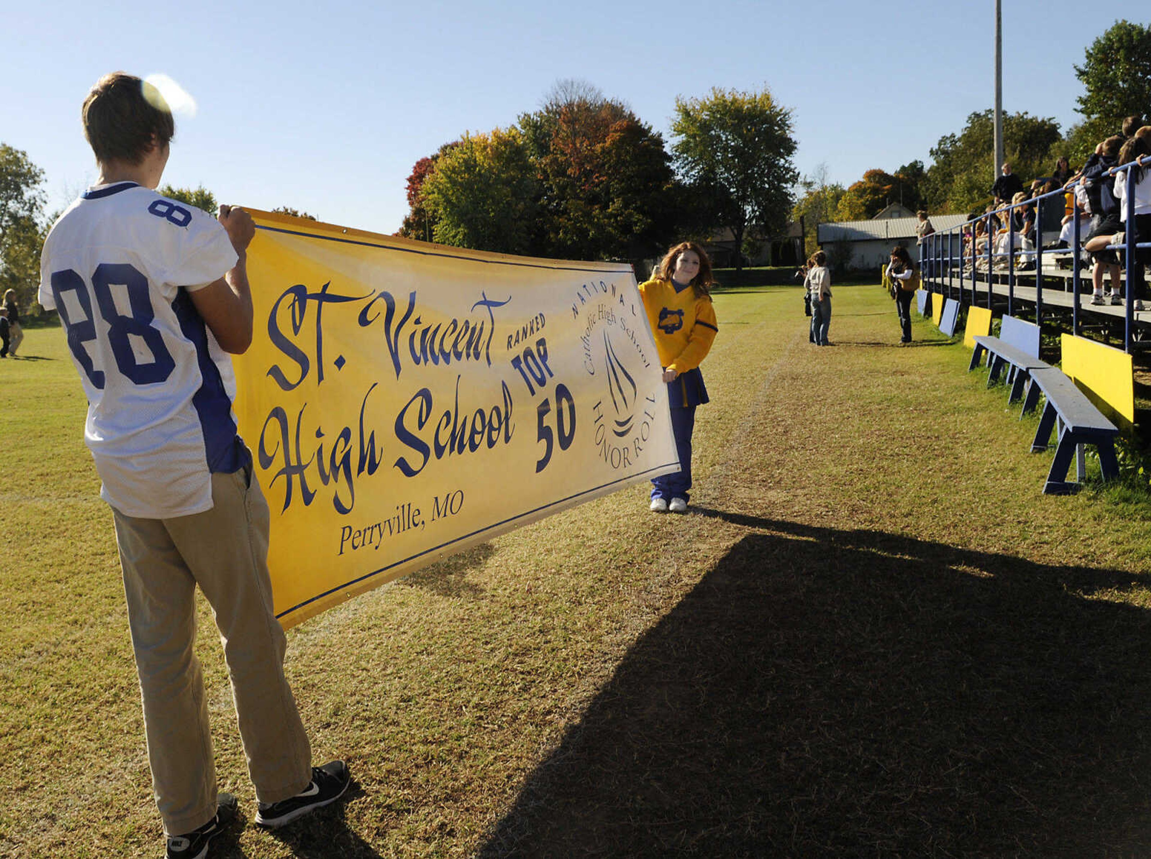 St. Vincent juniors Mark Kutz and Katie Franklin hold the banner during an assembly to celebrate the school's recognition on the list of the best 50 Catholic secondary schools in America, presented by the Catholic High School Honor Roll. This is the first time St. Vincent has received this distinction. (Kristin Eberts)