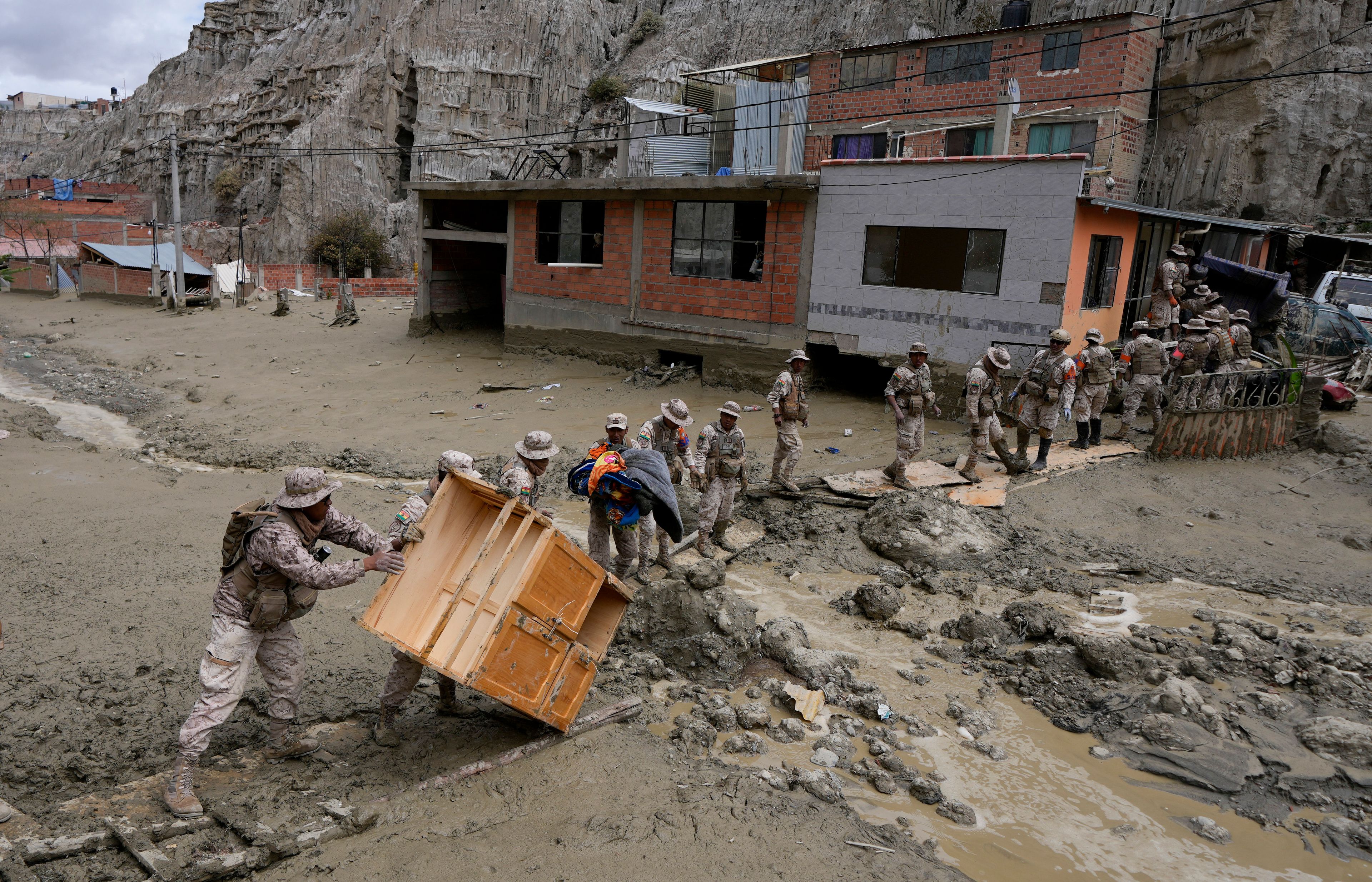 Soldiers recover a piece of furniture from a home flooded by a landslide caused by heavy rains in La Paz, Bolivia, Sunday, Nov. 24, 2024. (AP Photo/Juan Karita)