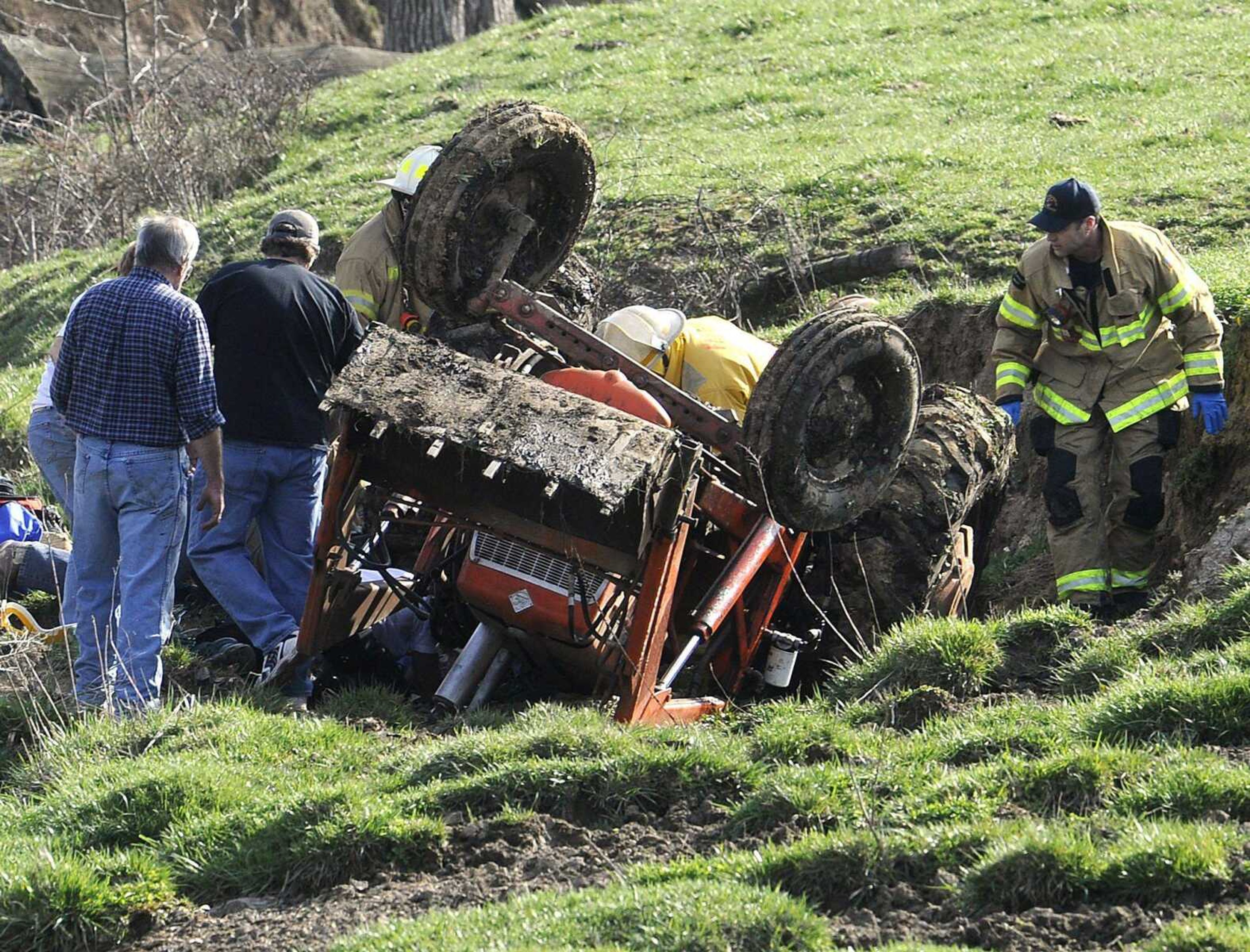 Emergency personnel respond to a tractor rollover accident on Cape Girardeau County Road 601 Friday afternoon, April 5, 2013 near Fruitland. Wayne Estes escaped with relatively minor injuries. (Fred Lynch)