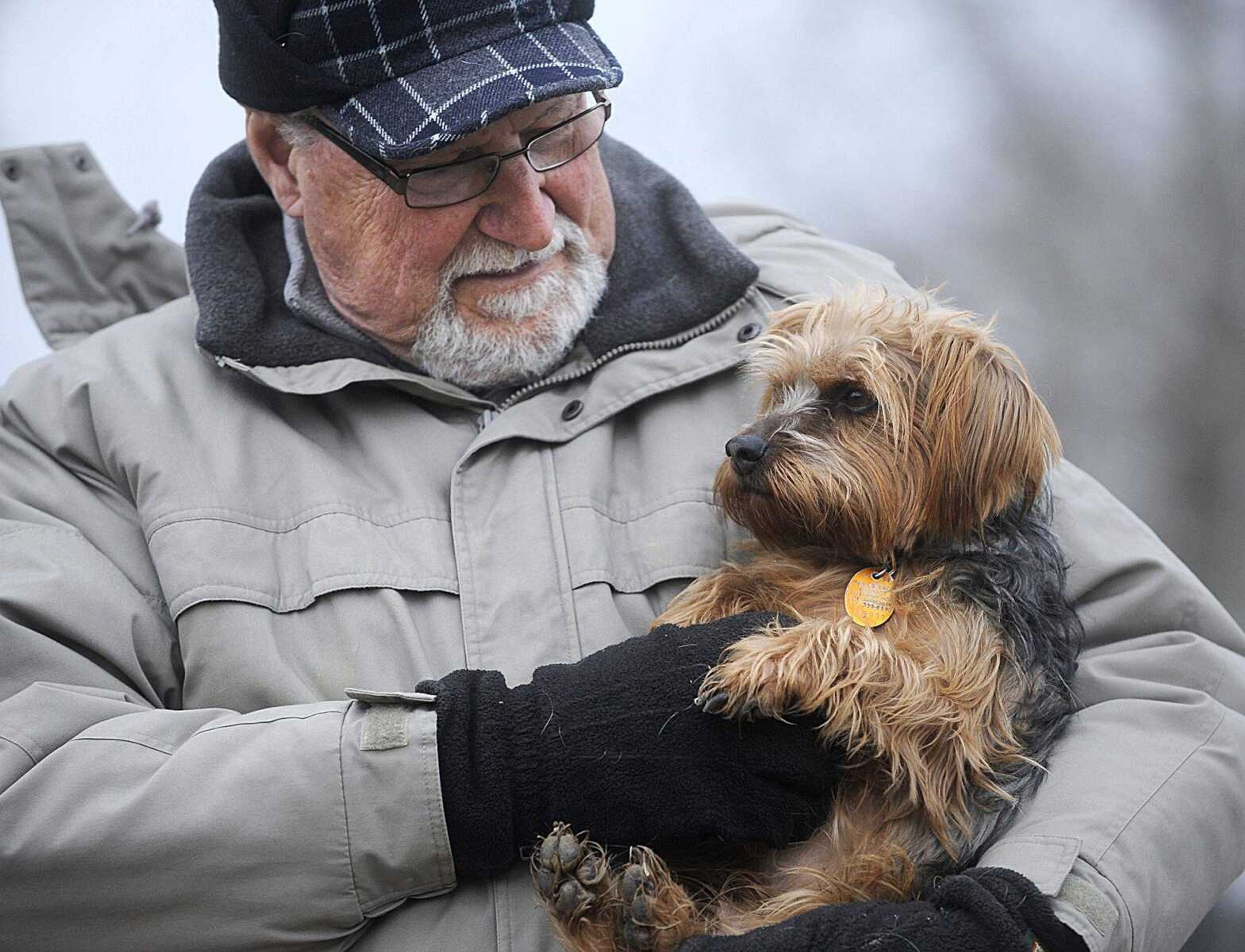 Ron Unterreiner holds his dog, Charlie, after a play date at the dog park at Kiwanis Park in Cape Girardeau Jan. 14. (Laura Simon)