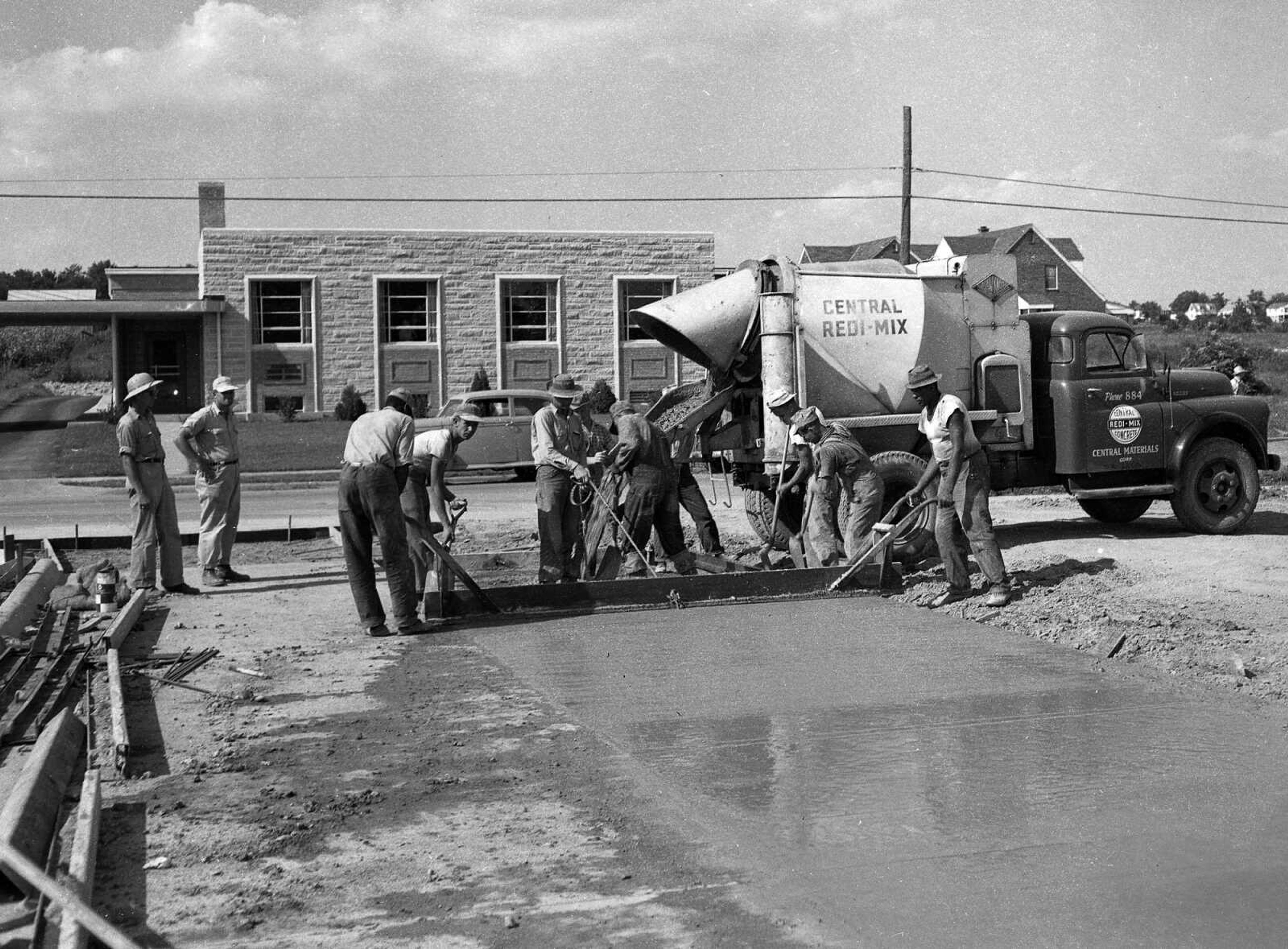 Workers with Central Redi-Mix poured a cement driveway. Do you recognize where this photo was made? Charles Herbst wrote: "Pic 4 of 7 looks like Cordelia Street being paved?" Bill Stone agreed: "I believe they are pouring Cordelia Street where it connects to Broadway.I recognize the buildings and the homes in the background."