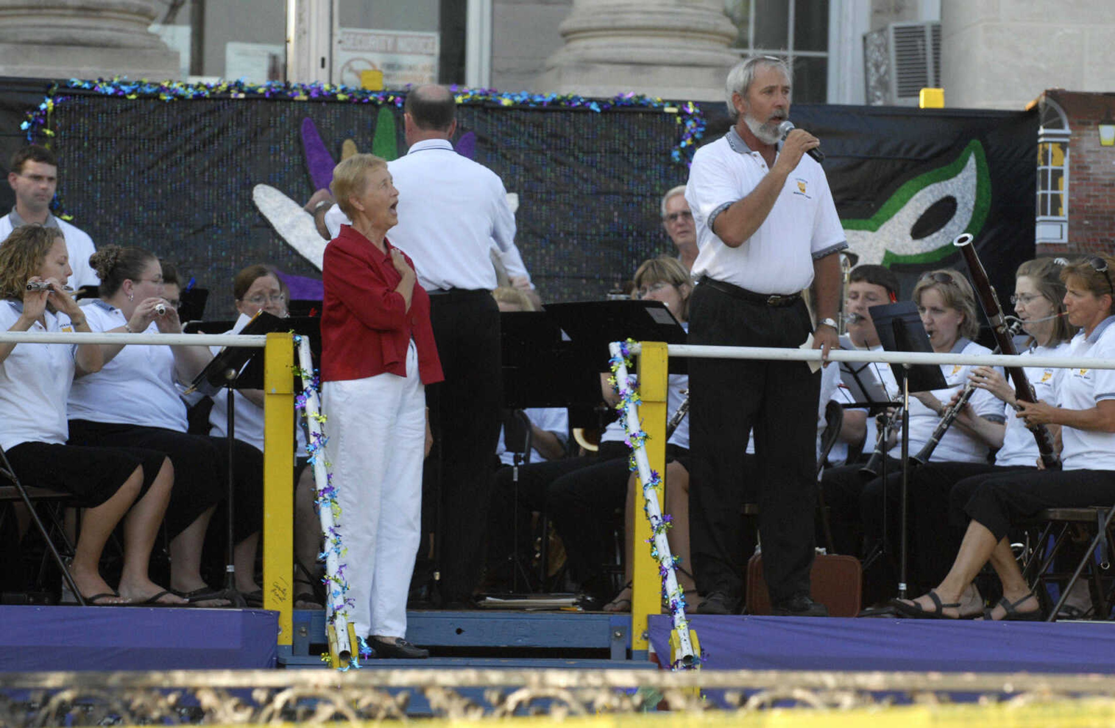 KRISTIN EBERTS ~ keberts@semissourian.com

Mayor Barbara Lohr sings the National Anthem with the Jackson Municipal Band as they kick off the 102nd Annual Homecomers Celebration in downtown Jackson on Tuesday, July 27, 2010. Tuesday marked the opening day of the celebration, which lasts through Saturday.