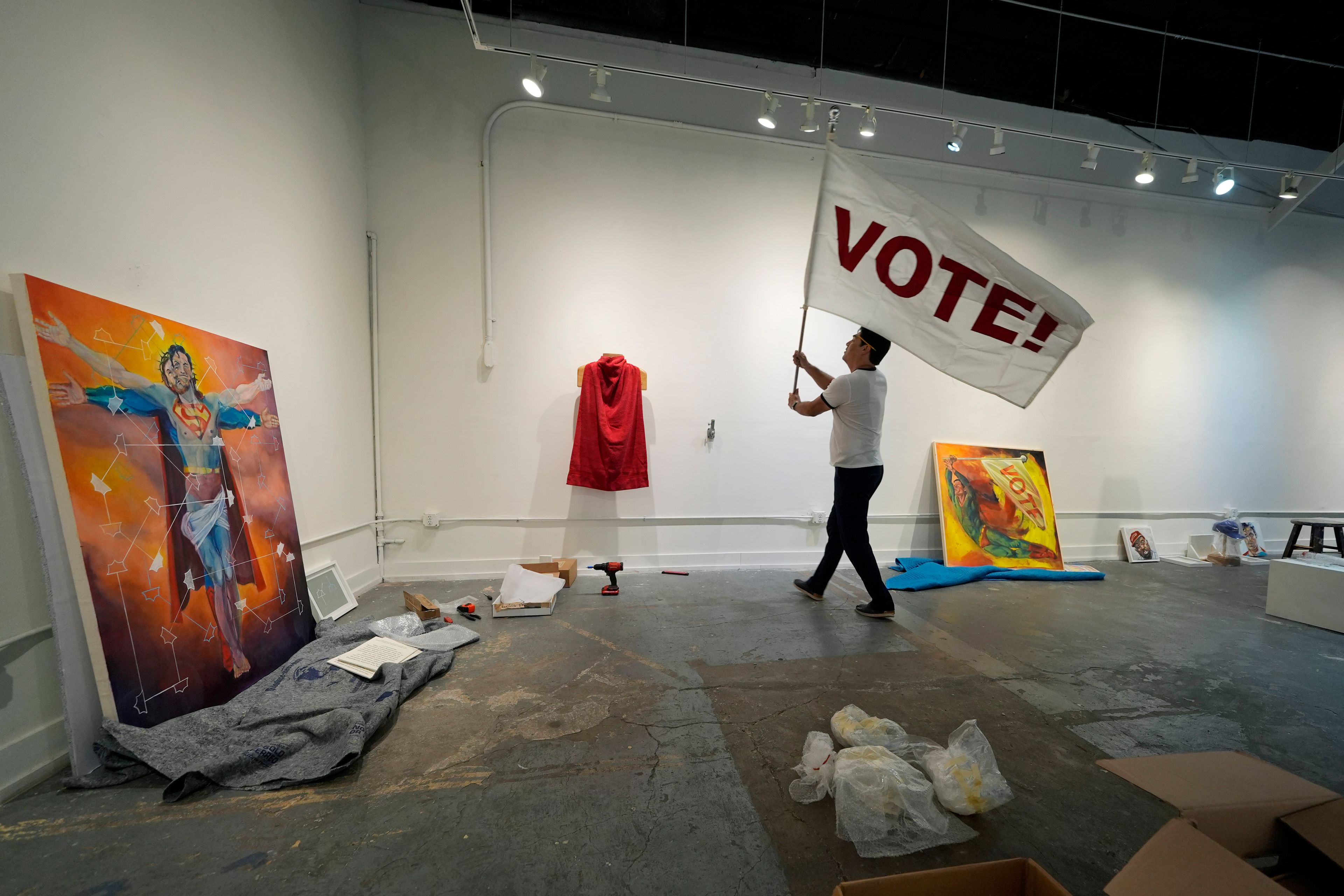 Artist David Alcantar prepares works of art from his "Superman Project" for an upcoming show in San Antonio, Monday, Sept. 30, 2024. (AP Photo/Eric Gay)