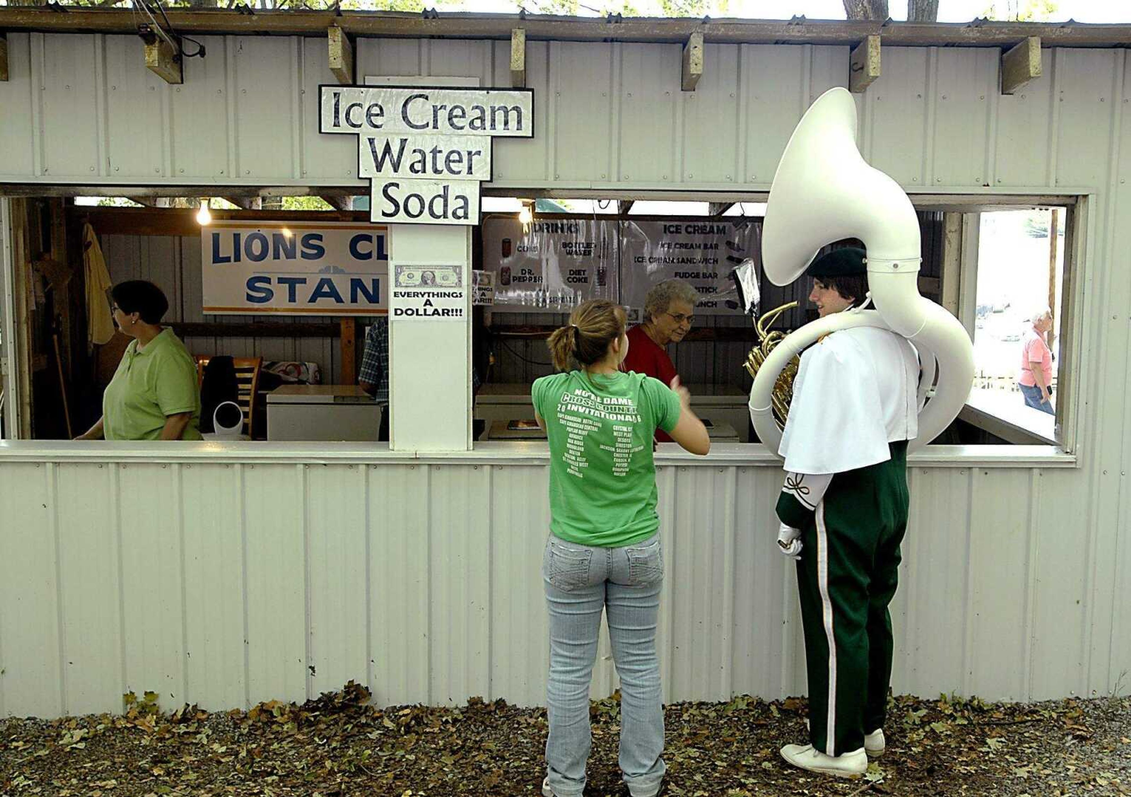 AARON EISENHAUER ~ aeisenhauer@semissourian.com
Michael Richardson, a sophomore sousaphone player in the Perryville marching band, gets a soda with Emily Westmorlan after the conclusion of the parade at the East Perry County Fair on Friday, September 19, 2008.