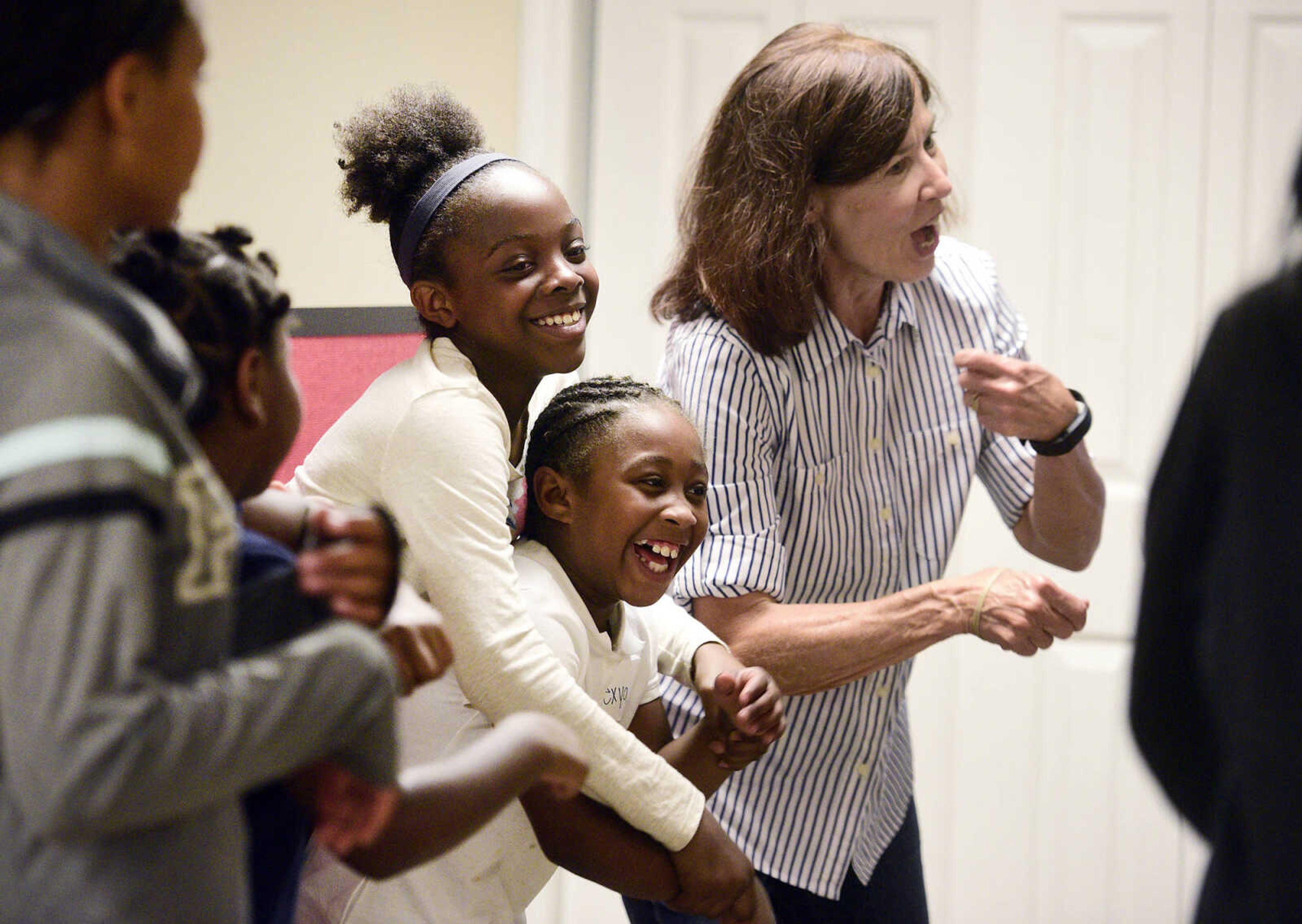 Marshauntis Washington, top center, dances with Alexya Jones and alongside Debbie Bowers on Monday, Aug. 14, 2017, during the Salvation Army's after school program at The Bridge Outreach Center in Cape Girardeau.