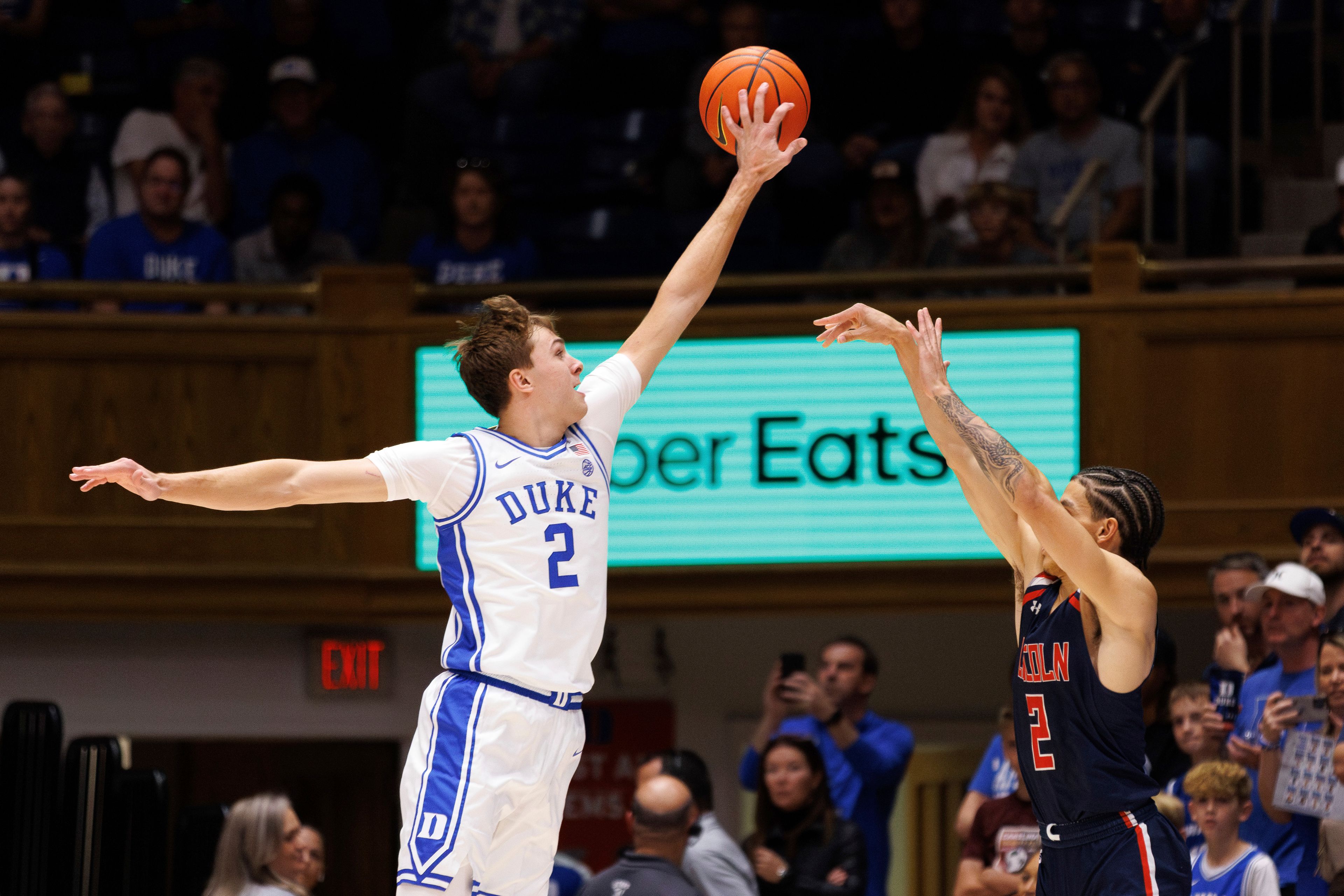 Duke's Cooper Flagg, left, blocks a shot from Lincoln's Freddie Young, right, during the first half of an exhibition NCAA college basketball game in Durham, N.C., Saturday, Oct. 19, 2024. (AP Photo/Ben McKeown)