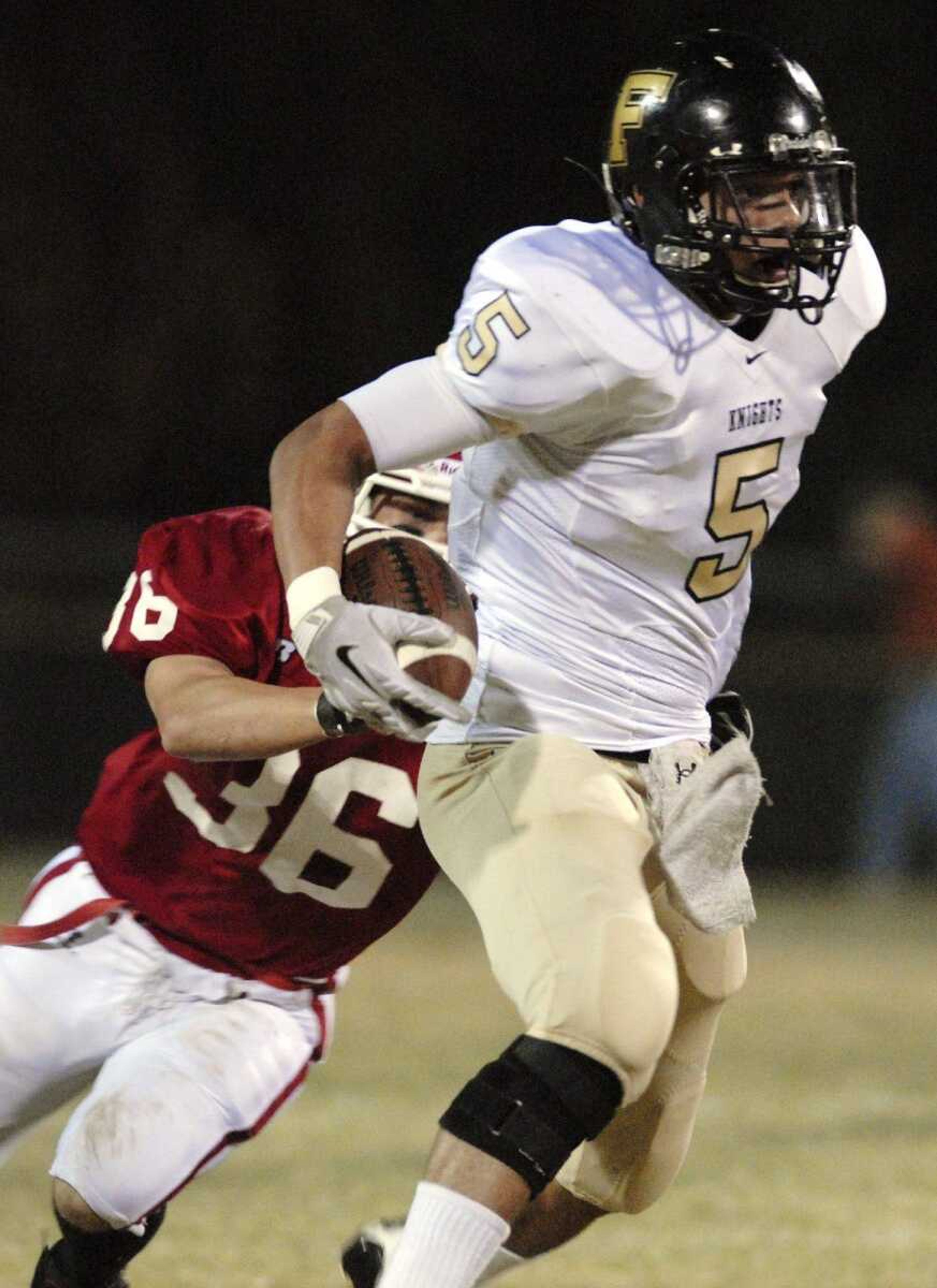 Farmington senior Jonathon Bird tries to break free from Jackson defender Kyle Greenwalt during last week's game in Jackson. (Laura Simon)