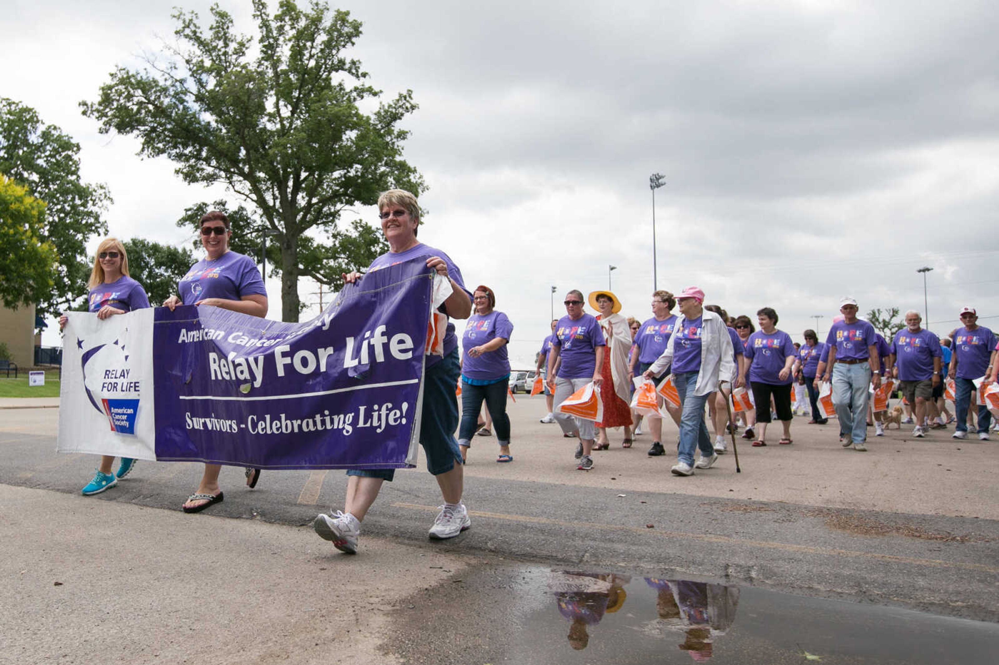 GLENN LANDBERG ~ glandberg@semissourian.com

Cancer survivors take the first walk around the track during the survivor's lap at the Relay for Life of Cape Girardeau County fundraiser at Arena Park, Saturday, June 13, 2015.