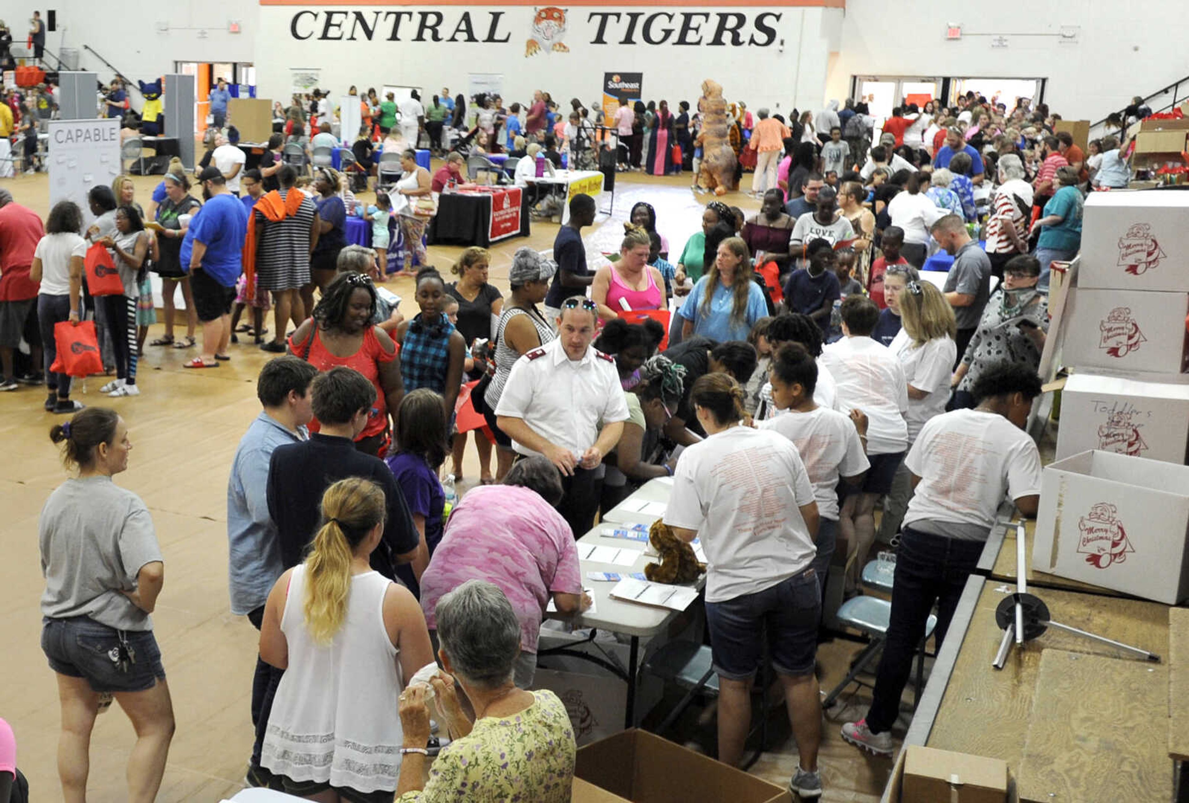 FRED LYNCH ~ flynch@semissourian.com
Lt. Matthew DeGonia overseas the Salvation Army booth Wednesday, Aug. 1, 2018 during the Back to School Kickoff at Central Junior High School Tiger Field House.