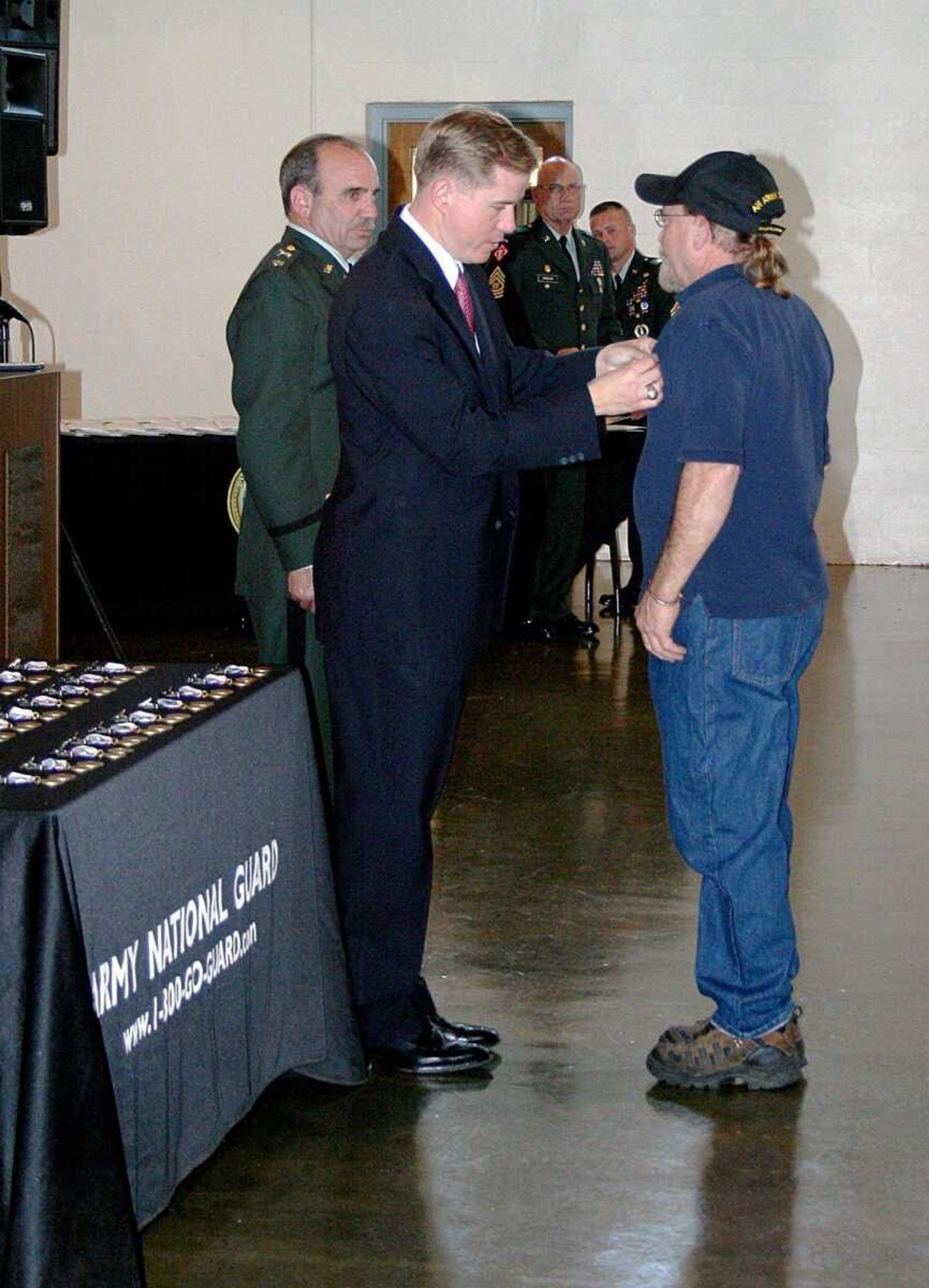 Gov. Matt Blunt placed a pin on one of the Vietnam veterans he honored Saturday at the Missouri National Guard Armory in Cape Girardeau. Forty-one veterans received pins, certificates and medallions recognizing their service. (Submitted photo)