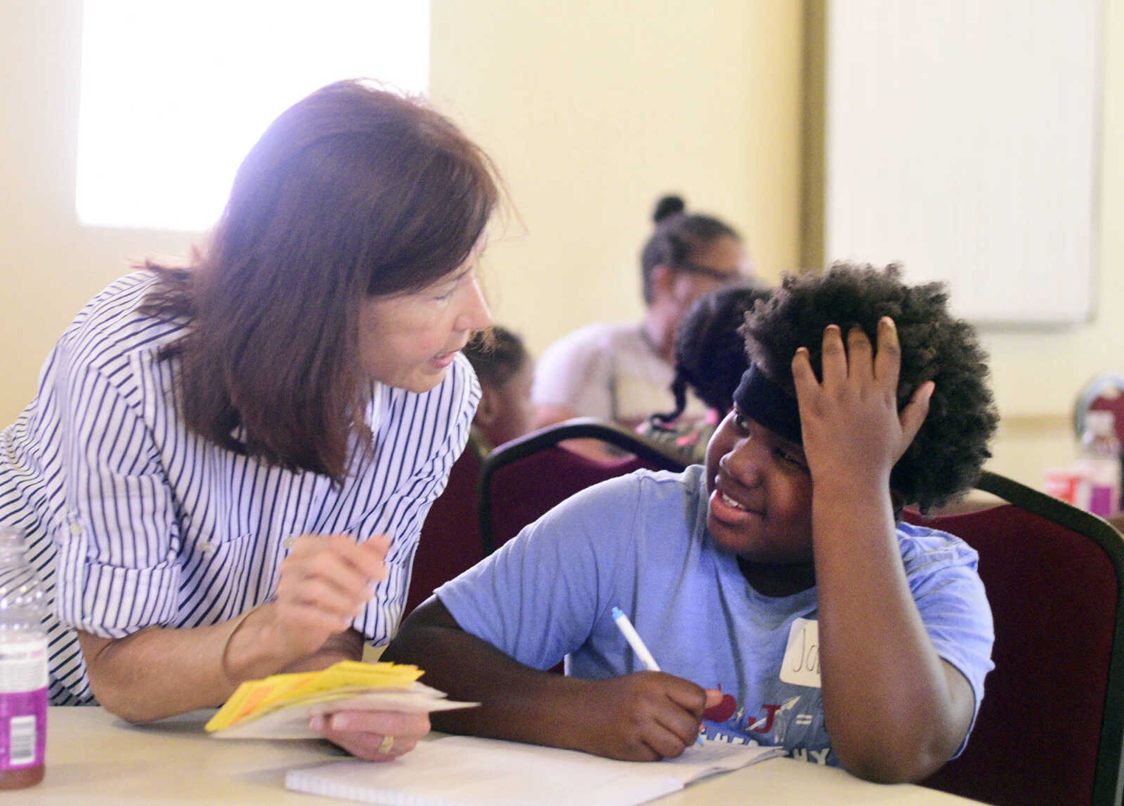 Debbie Bowers, left, helps Jamia Maney write three things she learned on Monday, Aug. 14, 2017, during the Salvation Army's after school program at The Bridge Outreach Center in Cape Girardeau.