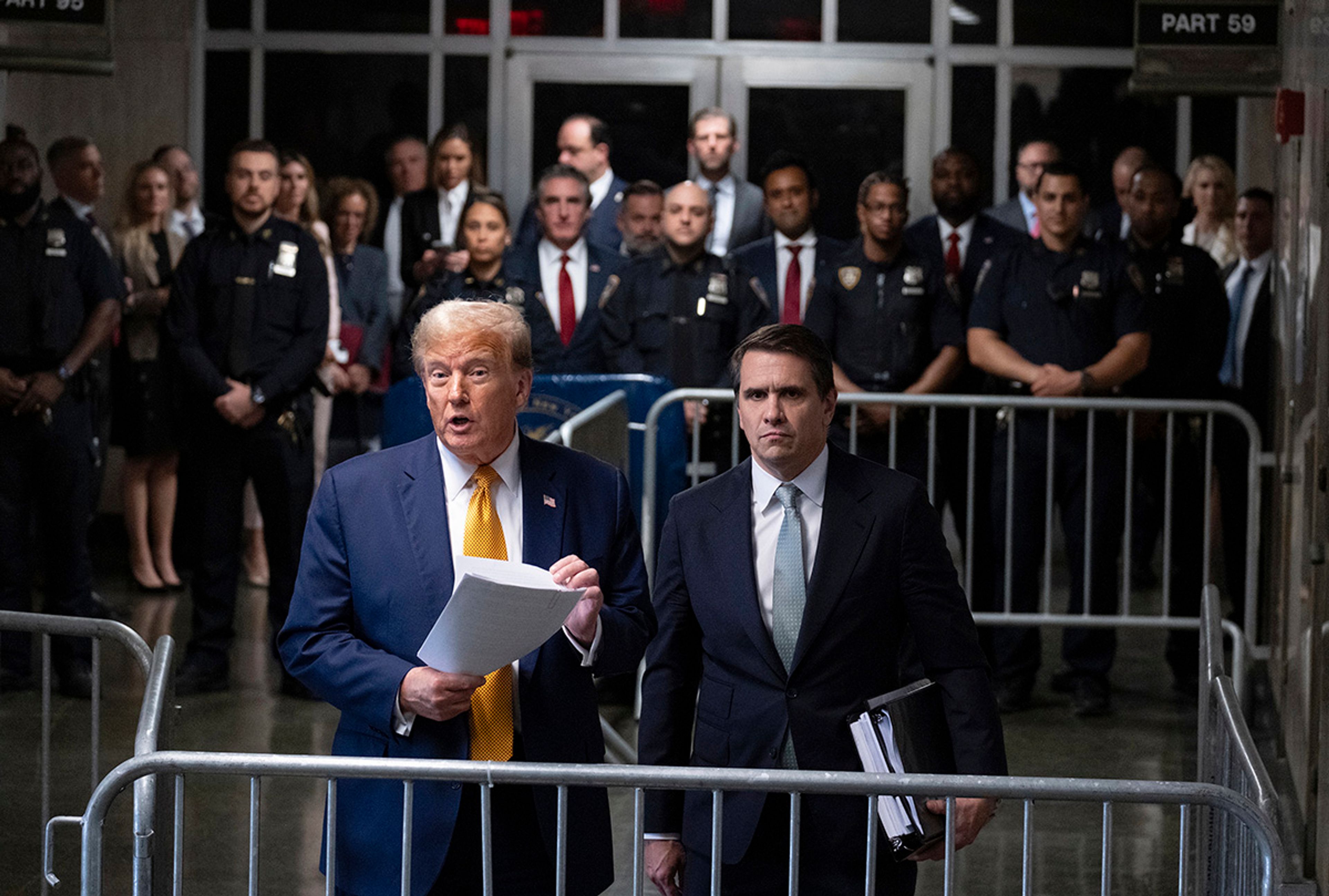 Former President Donald Trump, standing with defense attorney Todd Blanche, speaks at the conclusion of proceedings for the day at his trial at Manhattan criminal court, Tuesday, May 14, 2024, in New York. 