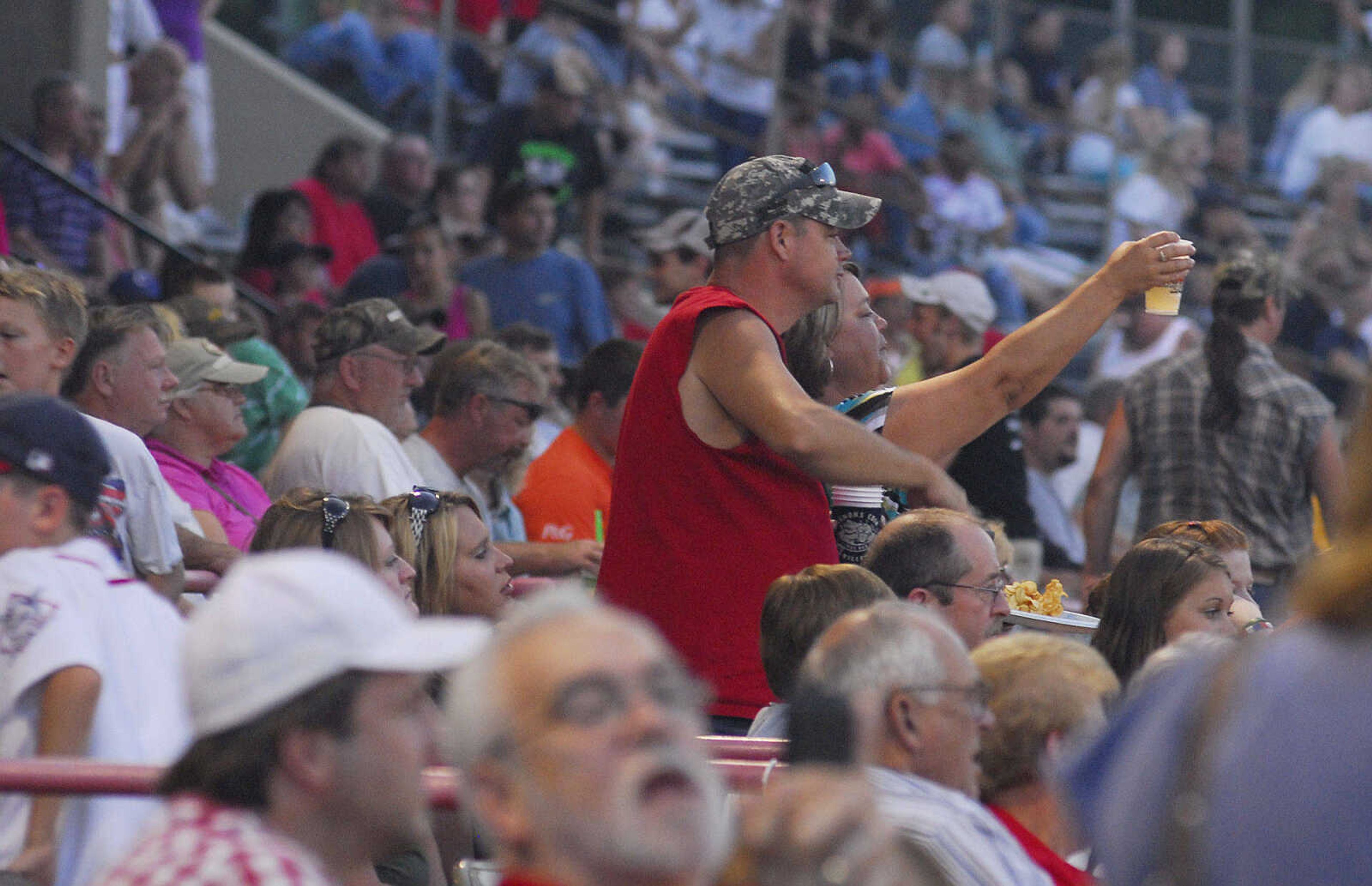 LAURA SIMON~lsimon@semissourian.com
Fans raise their glasses for Dual Demolition Derby during the U.S.A. Veterans Fourth of July celebration at Arena Park in Cape Girardeau Sunday, July 4, 2010.