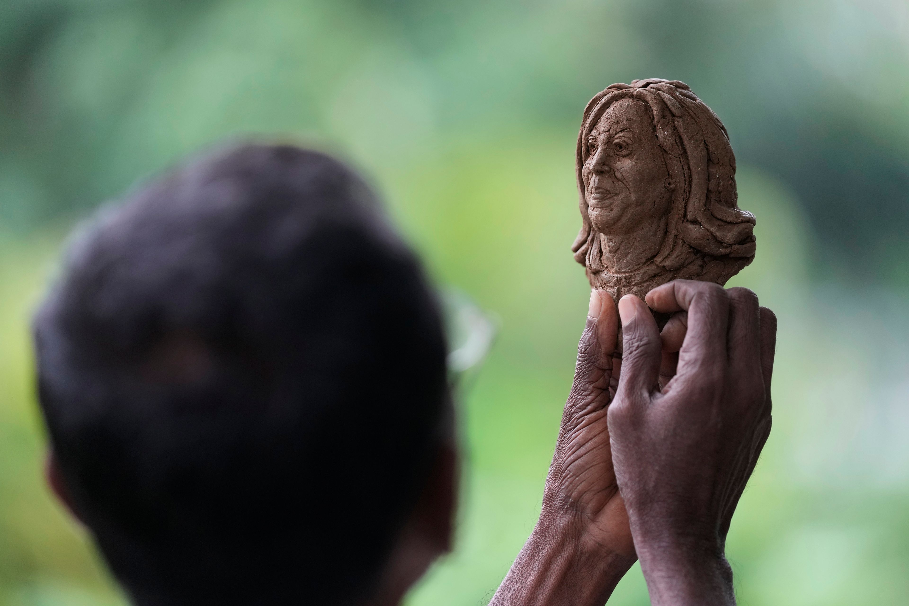 Artist Upali Dias holds a sculpture of US Vice President Kamala Harris in Colombo, Sri Lanka, Tuesday, Nov. 5, 2024. (AP Photo/Eranga Jayawardena)