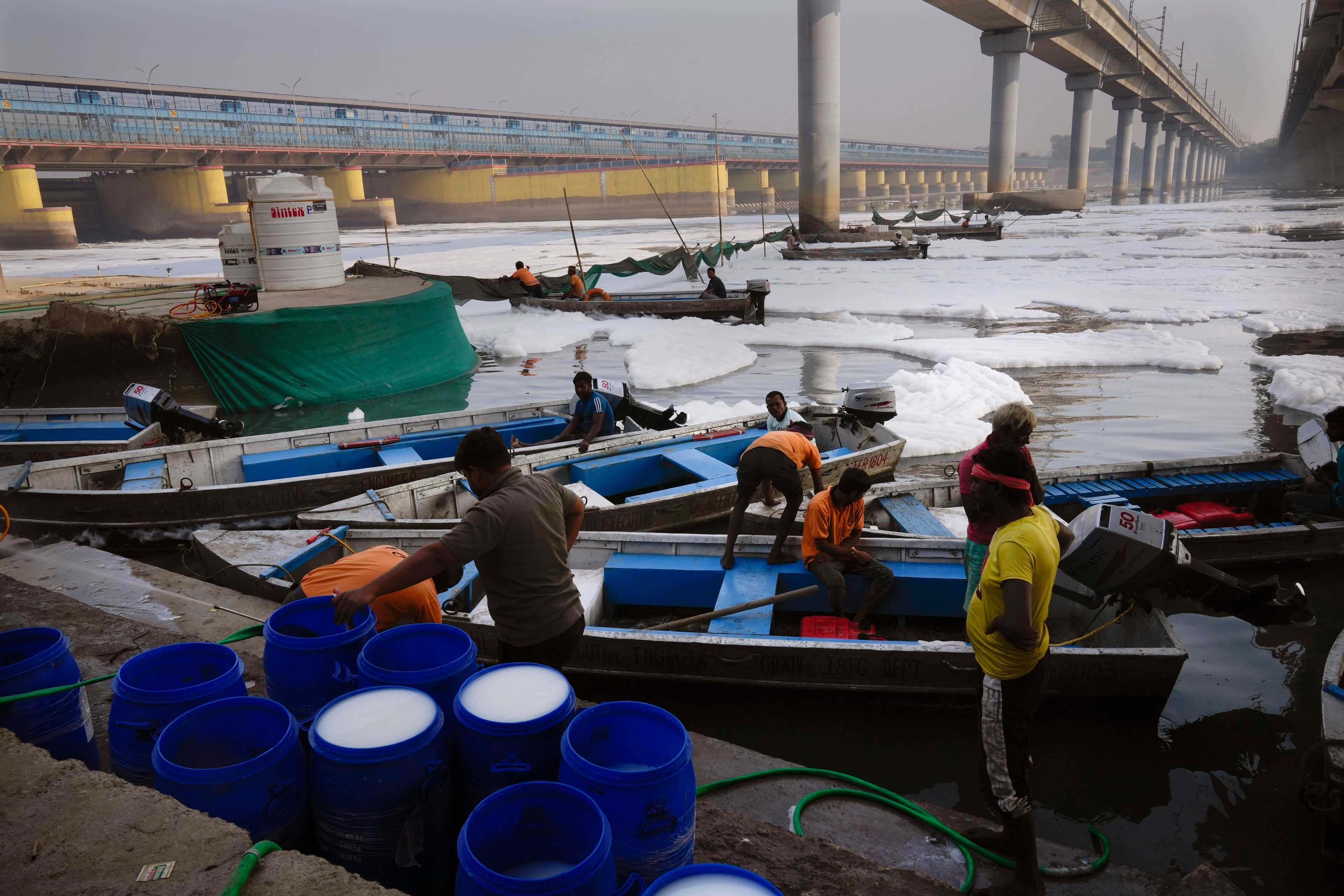 Workers for the Delhi Jal or water board gets ready to clean the toxic foams in the river Yamuna in New Delhi, India, Tuesday, Oct. 29, 2024. (AP Photo/Manish Swarup)