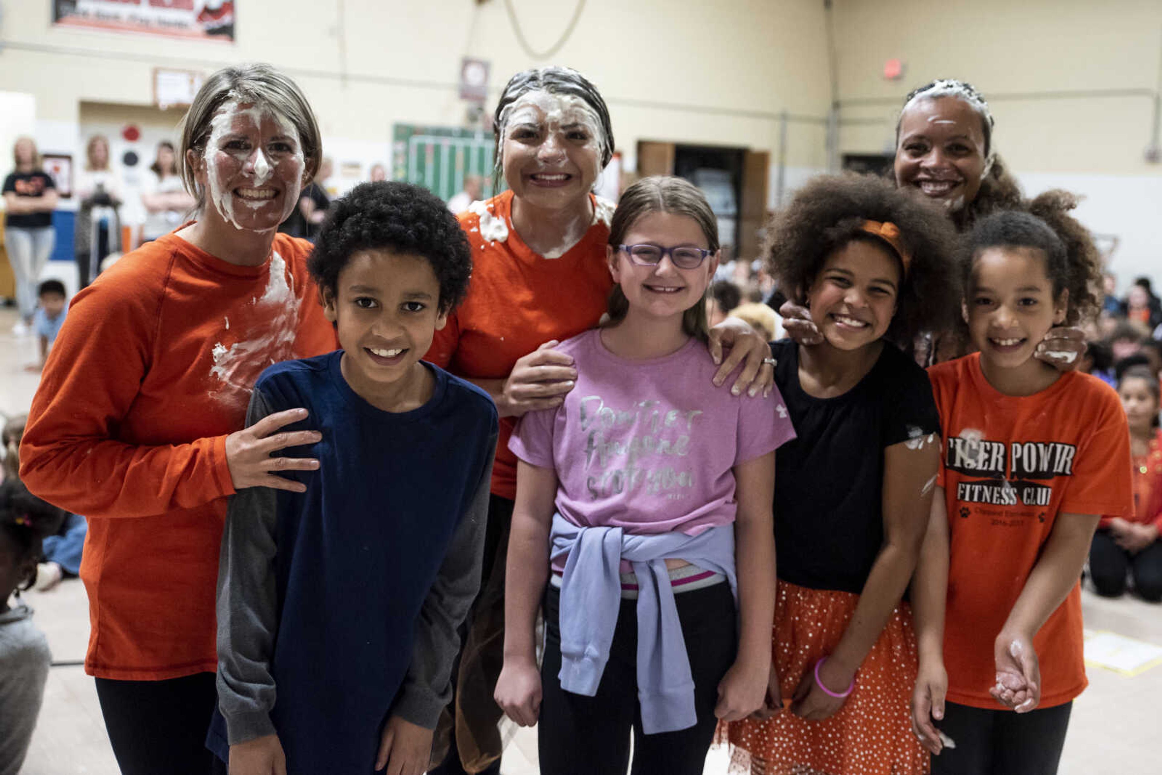 From left, faculty Amy Emmenderfer, Samantha Rose and Charity Owens smile for a photo with students (from left) Xavier Artis, Makayla Brockmire, Kayden Kirn and Jaymaia Ivory at Clippard Elementary School Friday, April 5, 2019, in Cape Girardeau. Students earned votes for which teacher(s) would get pied in the face when they brought in donations to raise money for their end-of-the-year play day that is free to students. Through students and other donations, the school raised $550 towards their play day activities.