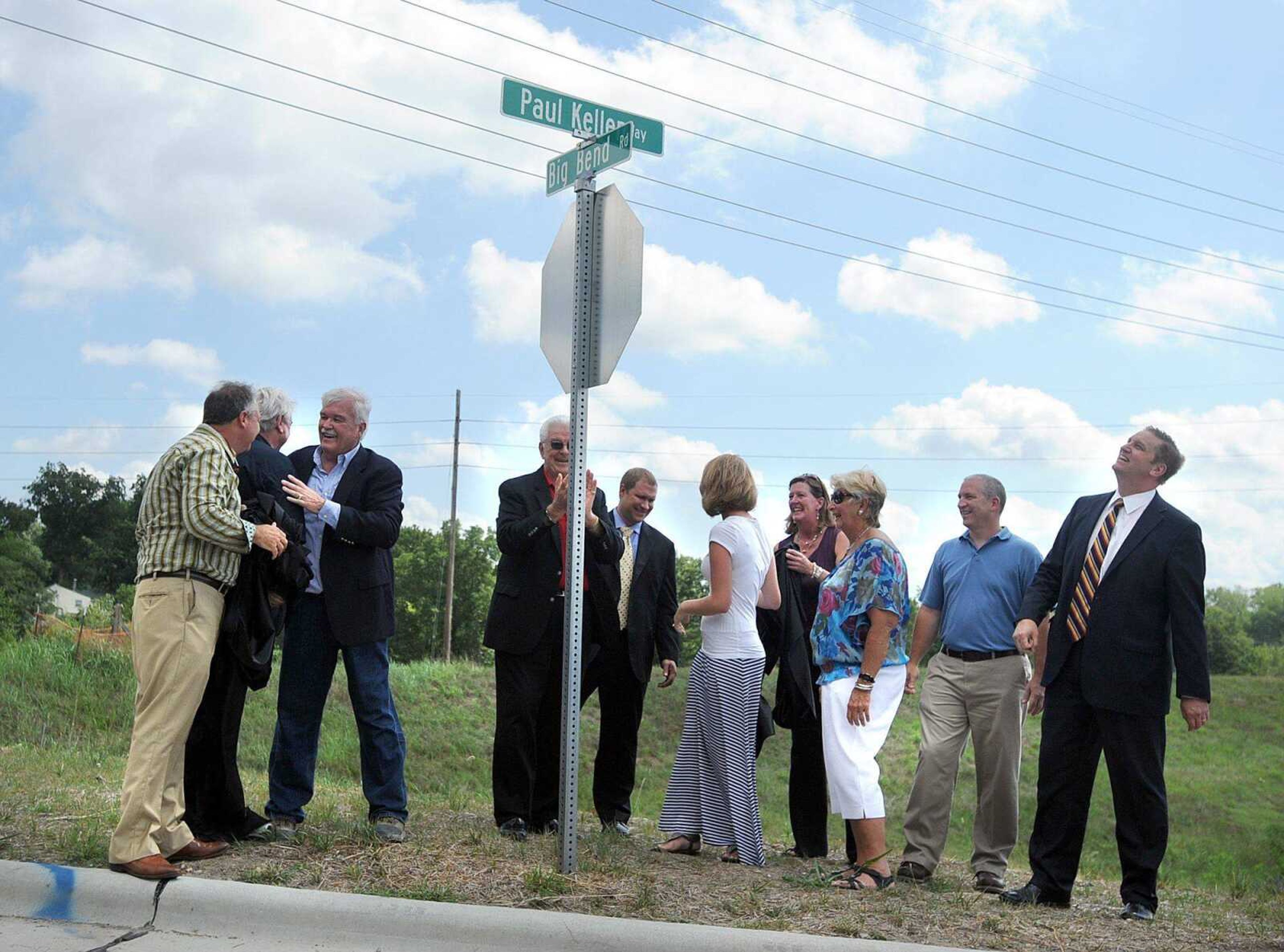 From left, Jim Riley, David Knight, Richard Meister, Cape Girardeau Mayor Harry Rediger, Trent Summers, Kelly Green, Isle of Capri CEO Virginia McDowell, Loretta Schneider, John Voss and Scott Meyer reveal Paul Keller Way, which leads to the Isle of Capri Monday, July 16, 2012 in Cape Girardeau. (Laura Simon)