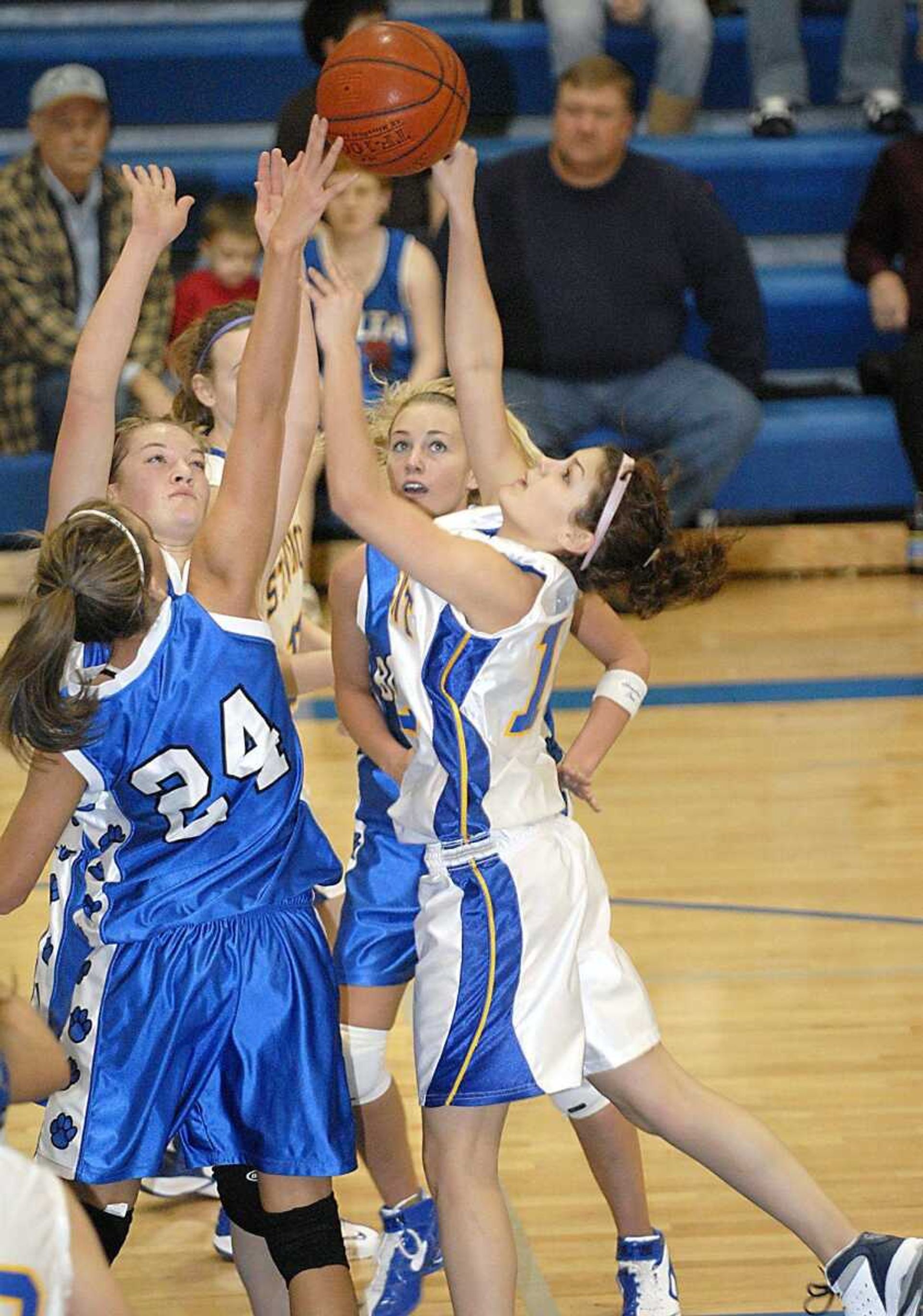 St. Vincent's Courtney Besand, right, had her shot blocked by Jodi Menz (24) as other Delta defenders closed in during the Delta New Year's Tournament championship game Saturday. (Kit Doyle)