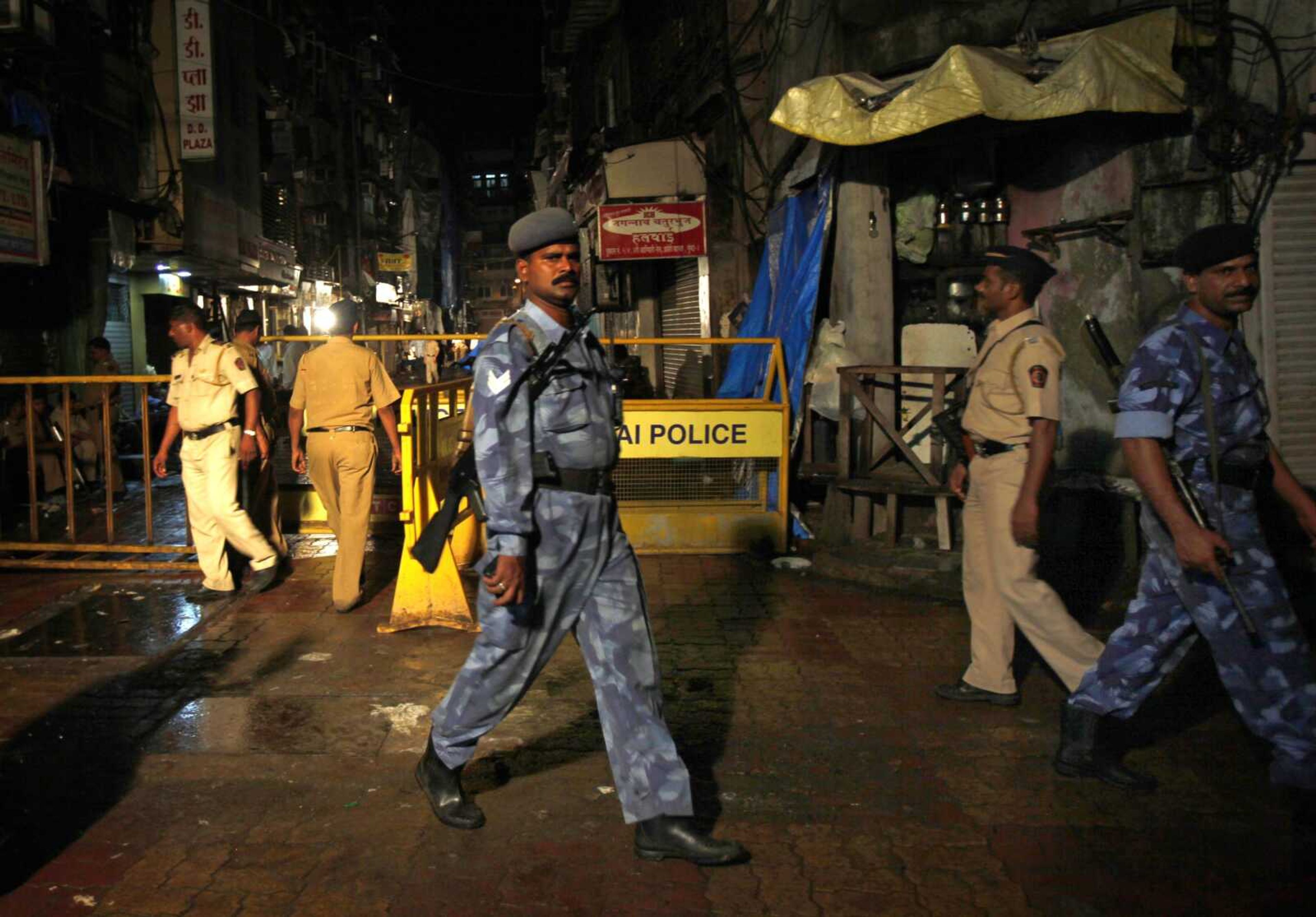 Members of police and Rapid Action Force guard Zaveri bazar Thursday, the site of an explosion Wednesday in Mumbai, India. (Aijaz Rahi ~ Associated Press)