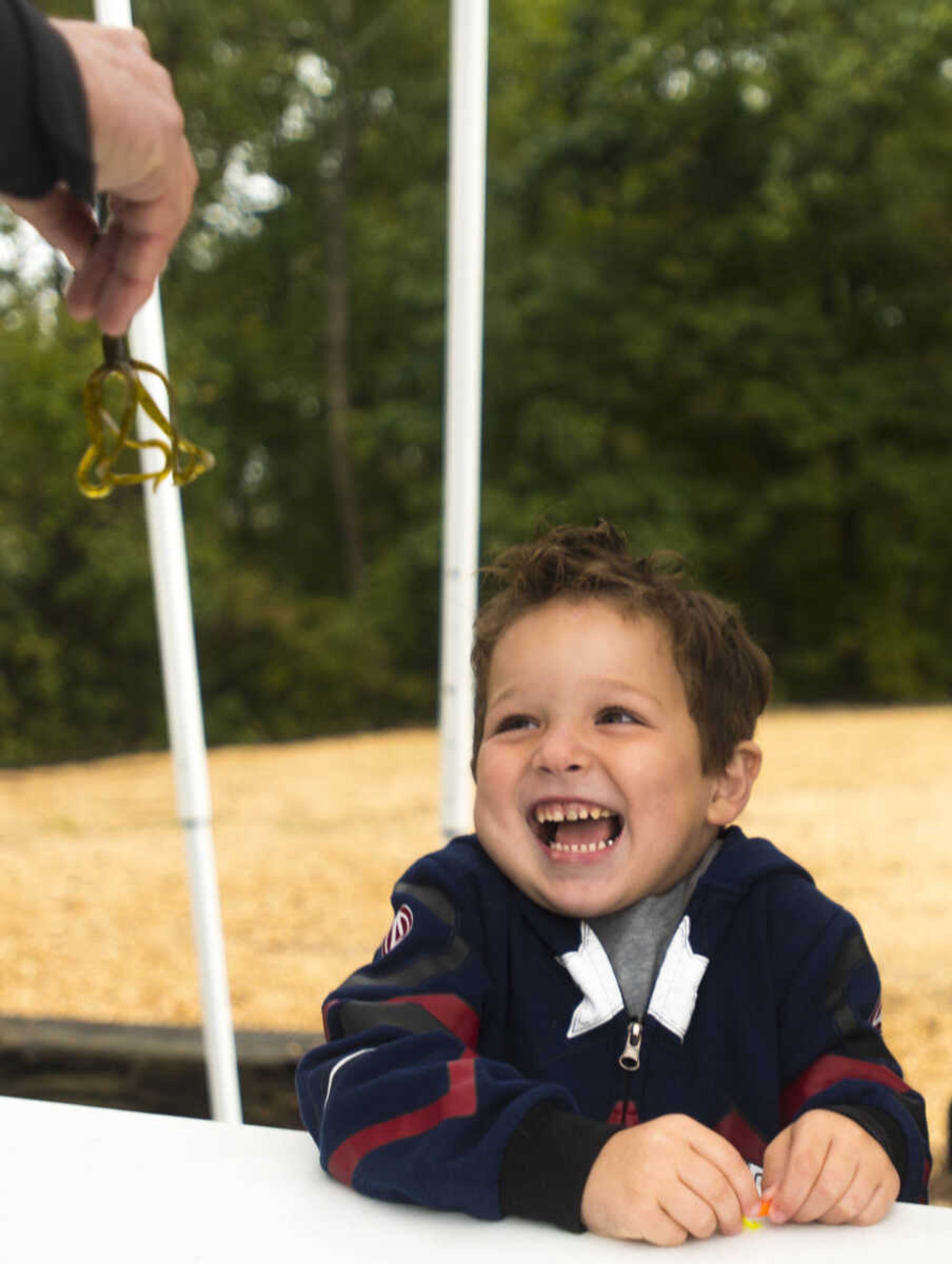 Peyton Scheper, 3, lets out a scream after seeing a fishing lure at the inaugural Fishing Rodeo held Oct. 15, 2017 at Elks Lake in Cape Girardeau.