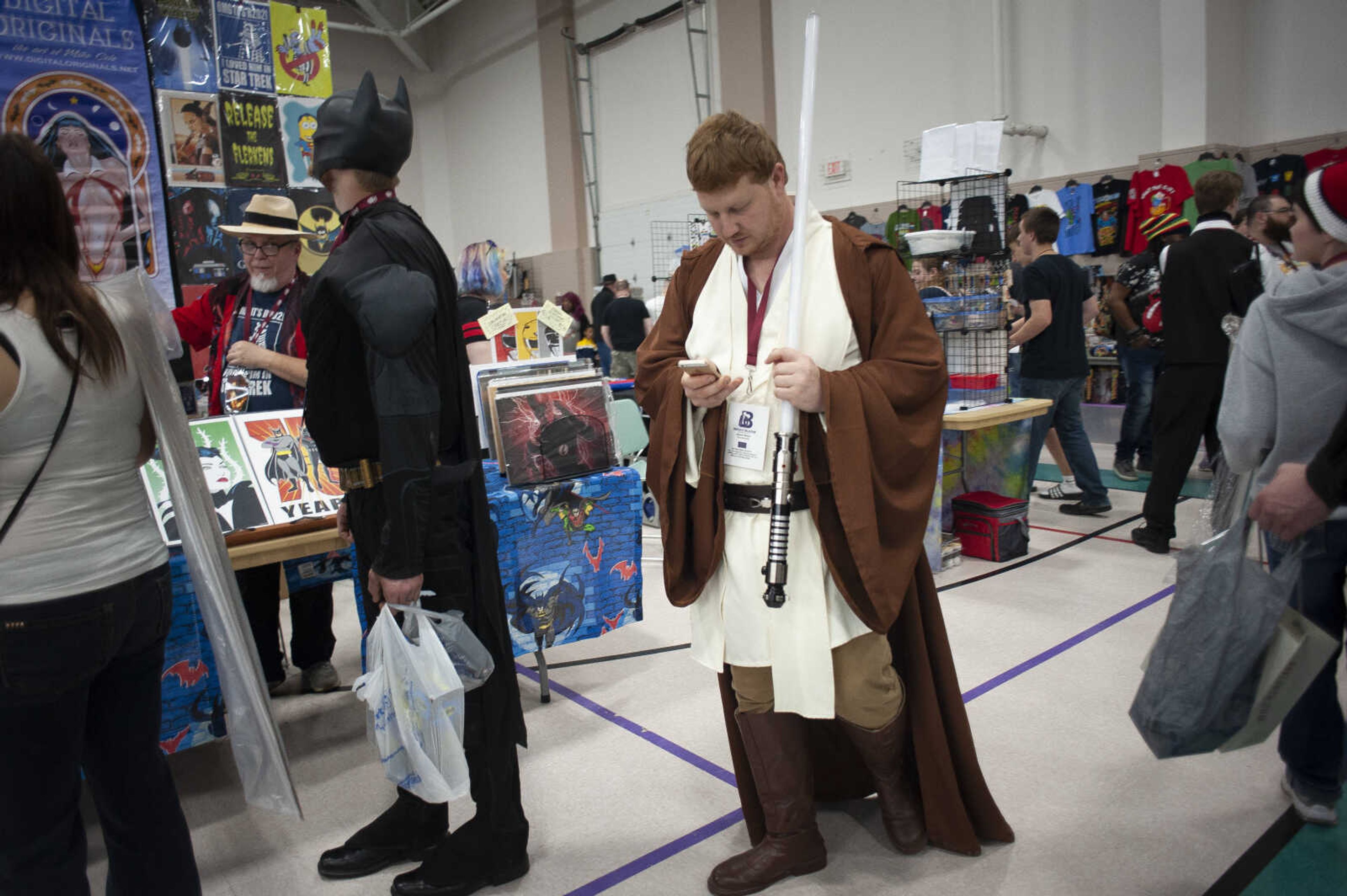 Nathan Wareing of Jackson looks at a phone while sporting an Obi-Wan Kenobi outfit during Cape Comic Con on Saturday, April 27, 2019, at the Osage Centre in Cape Girardeau.