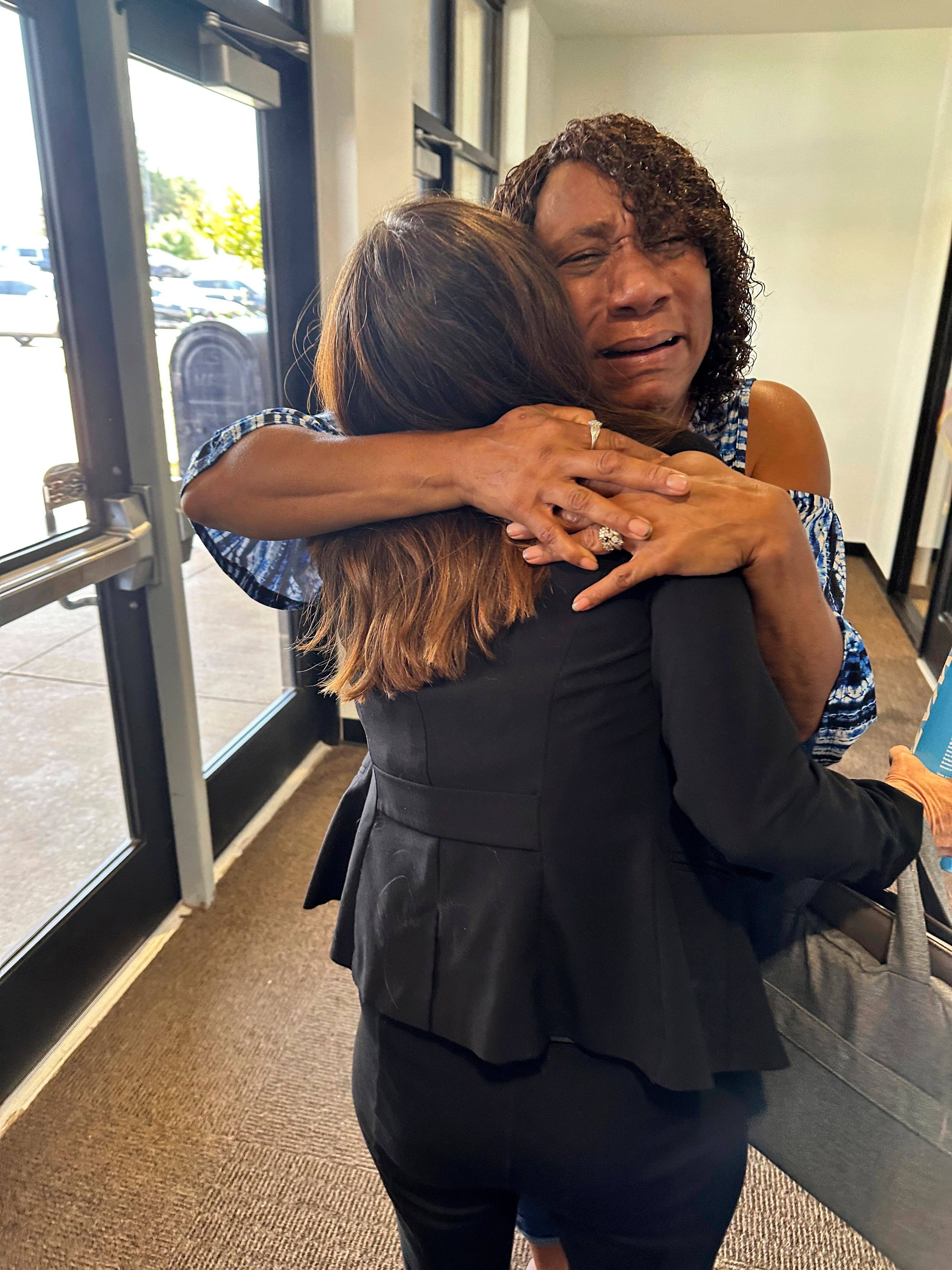 FILE - Augustina Sanders hugs Kim Ludwig, a paralegal in the Federal Public Defender's Office in Oklahoma City, after the Oklahoma Pardon and Parole Board voted 3-2 to recommend clemency for Sanders' brother, Emmanuel Littlejohn, Aug. 7, 2024. (AP Photo/Sean Murphy, File)