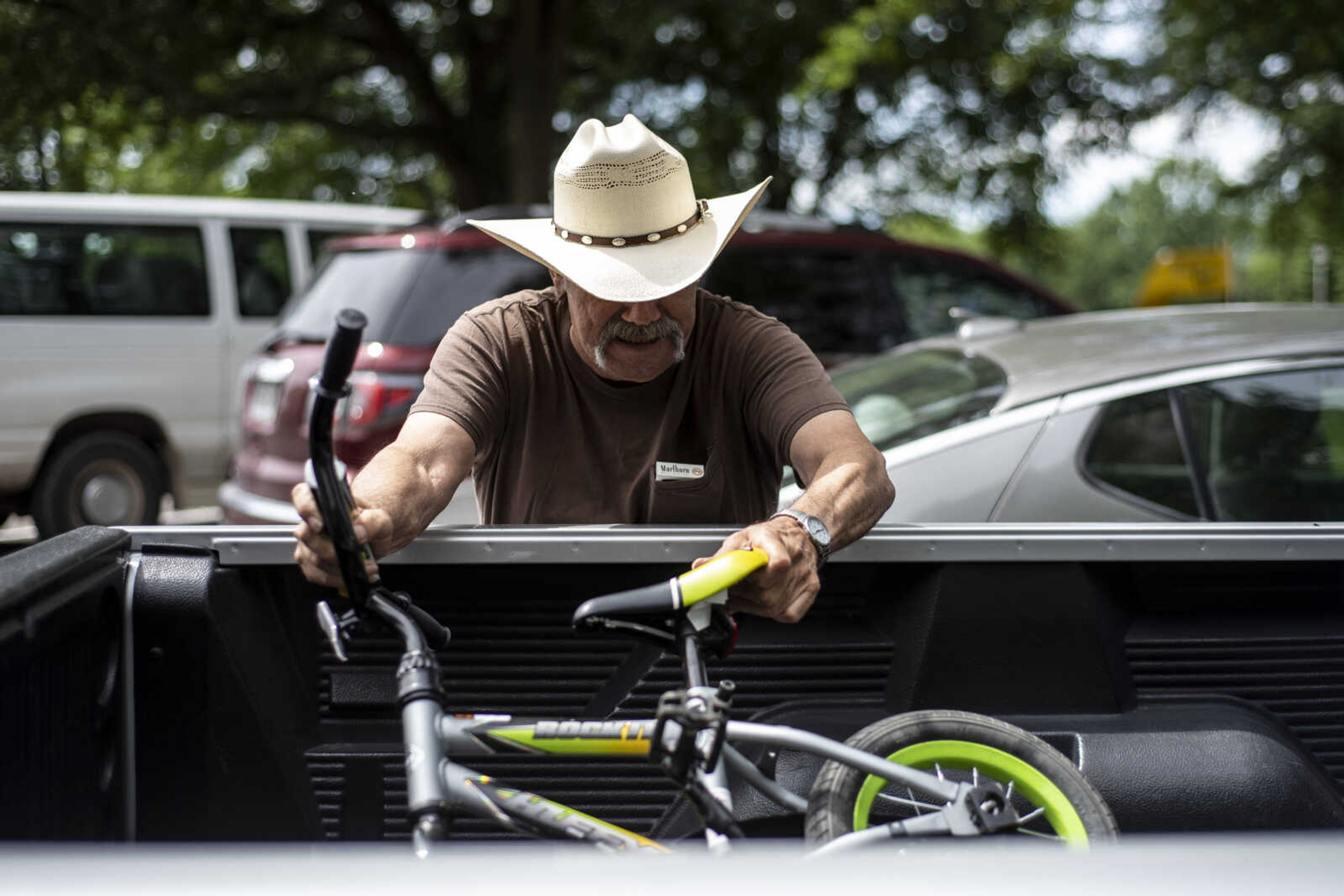 Carl Holmes loads his great-grandson Jayce Holmes's, 5, bike into the back of his truck after Jayce spent part of the afternoon riding around Safety City USA at City Park Tuesday, June 11, 2019, in Jackson.