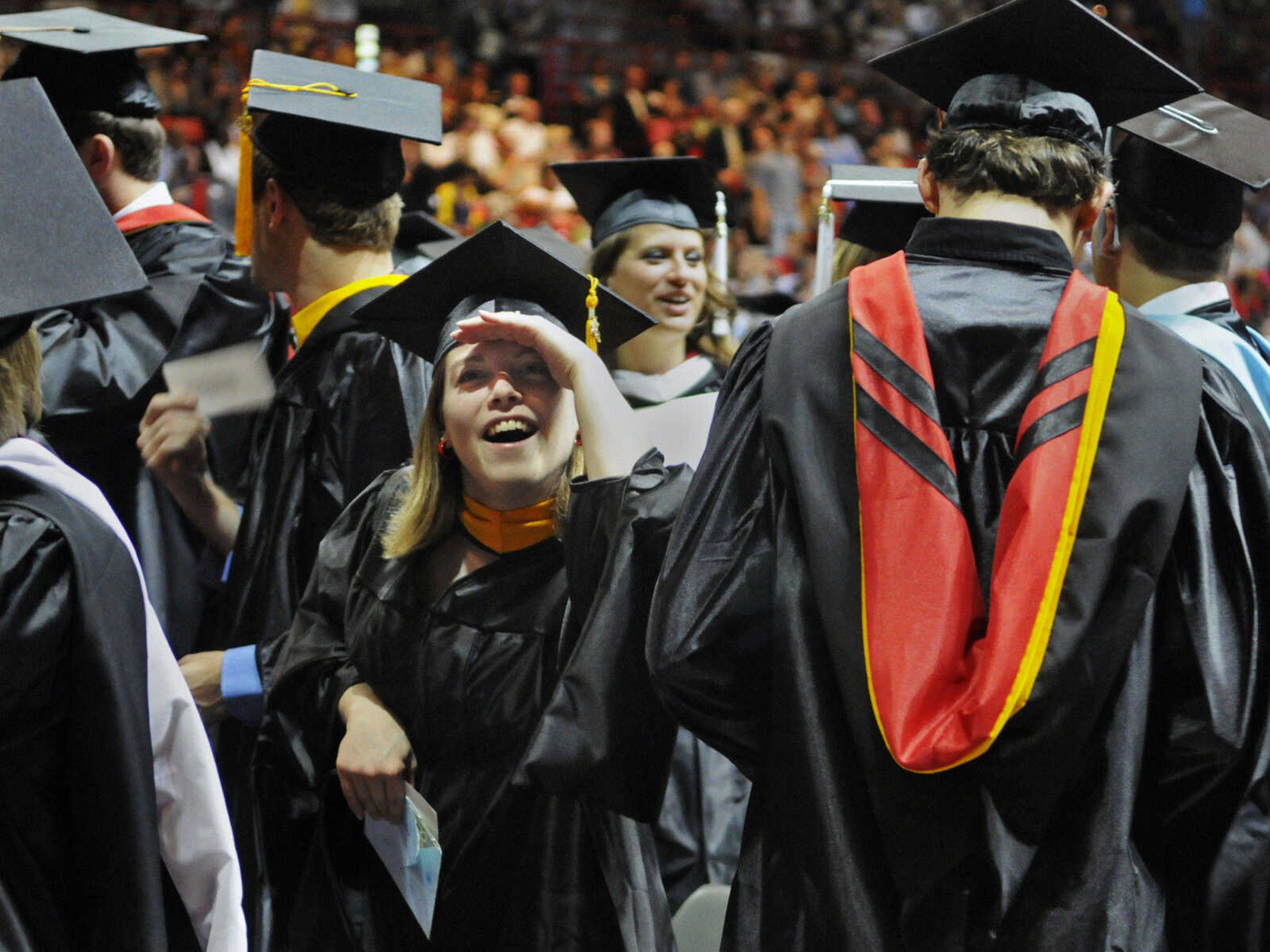 KRISTIN EBERTS ~ keberts@semissourian.com

Graduate student Rebecca Everding looks into the stands for family and friends during Southeast Missouri State University's 2010 Commencement at the Show Me Center on Saturday, May 15.