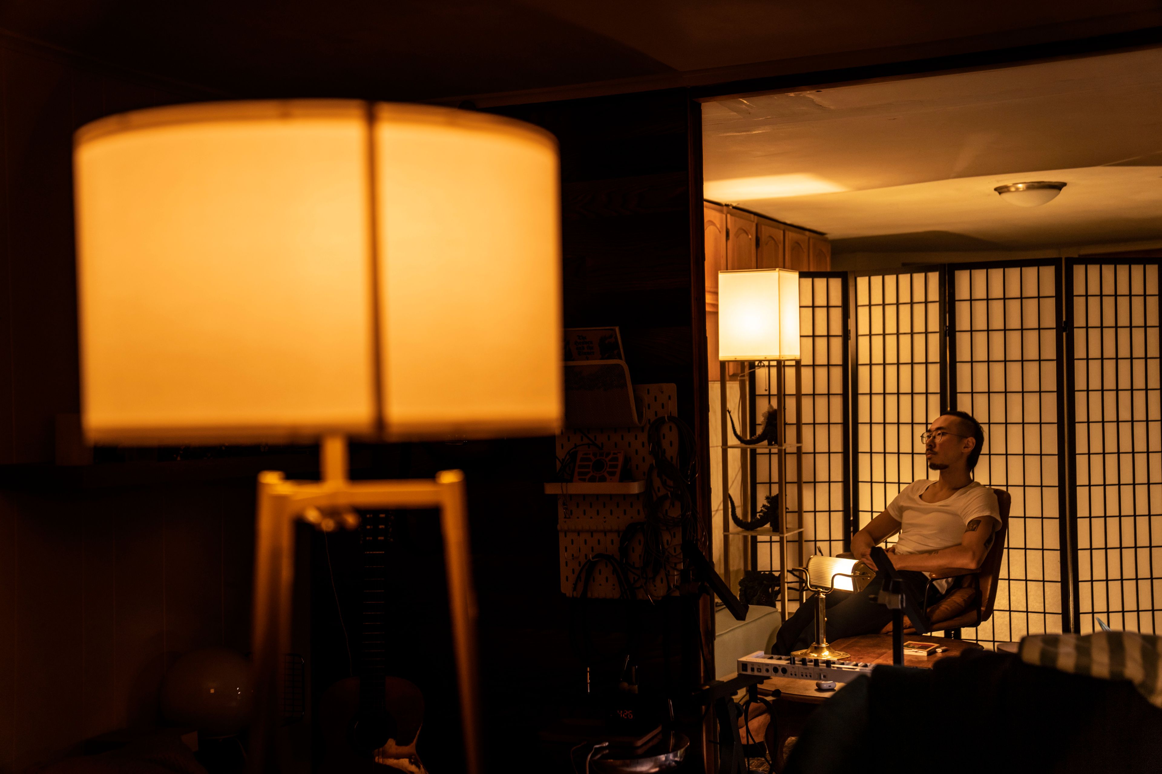 Robert Calabretta, who was adopted as a baby out of South Korea to an American family, sits in his apartment, Thursday, Feb. 15, 2024, in New York. (AP Photo/David Goldman)