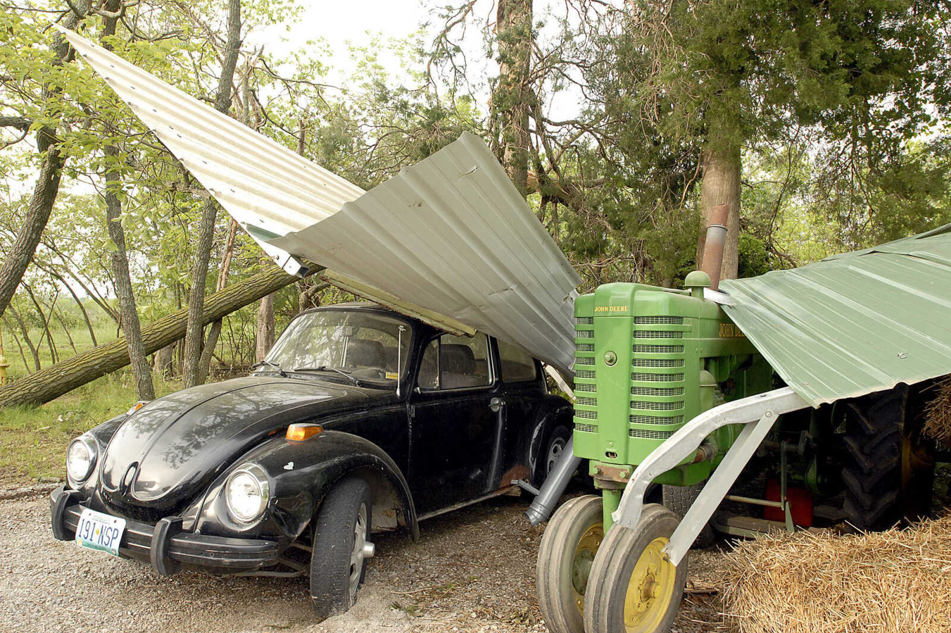 ELIZABETH DODD ~ edodd@semissourian.com
Pieces of a carport remain on top of a Volkswagen at the Gerecke home in Altenburg. "The car was a work in progress but now an even bigger work in progess," said Doris Gerecke. This is the second shed the Gereckes have lost to a storm.