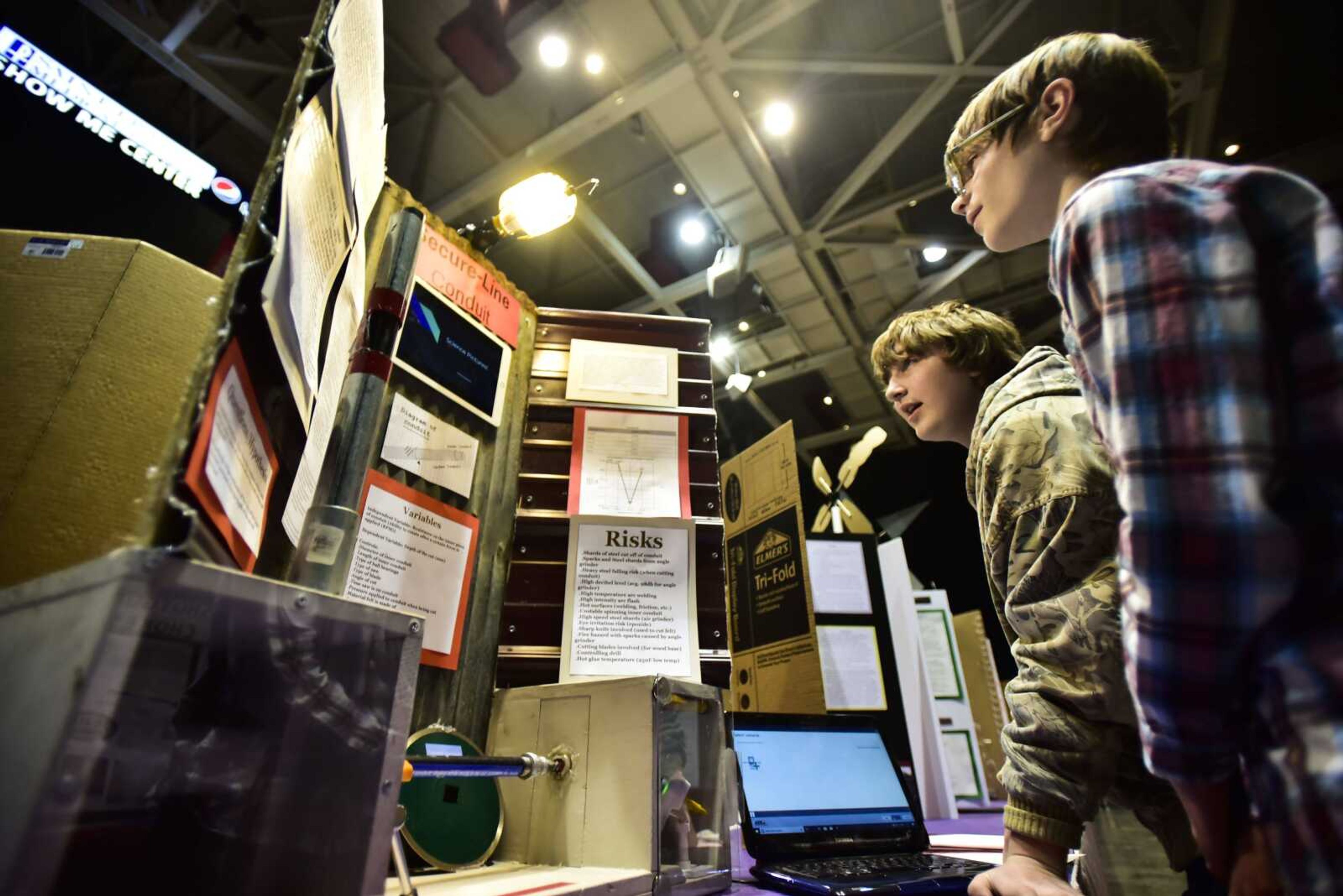 From left, Jackson students Hunter Rees and Eli Jones, both 15, make last-minute adjustments to their display before judging begins at the 62nd annual Southeast Missouri Regional Science Fair on Tuesday at the Show Me Center in Cape Girardeau.