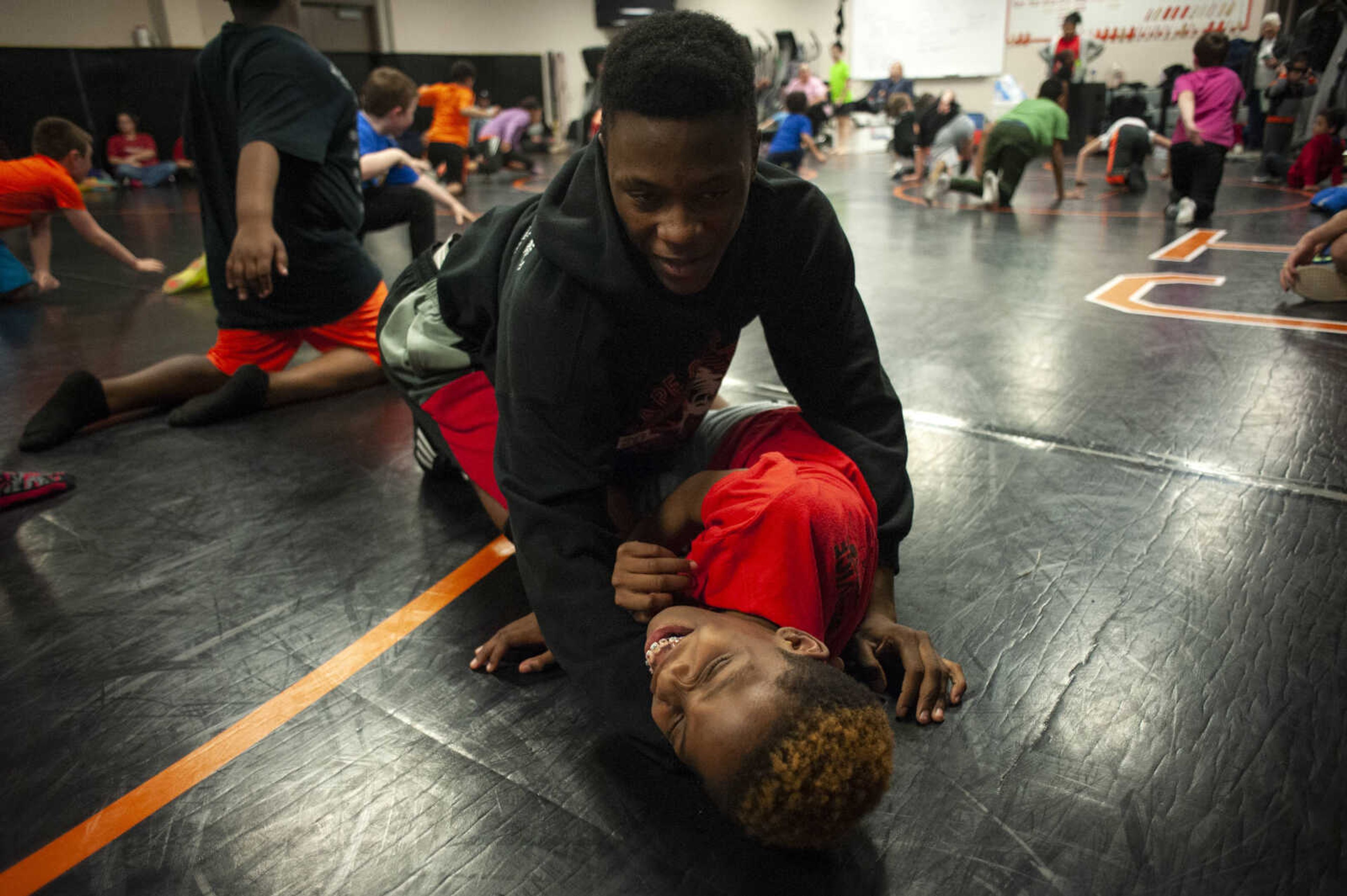 Davion Steele of Cape Girardeau, 16, works with Demarion Brown of Cape Girardeau, 13, in an exercise during practice Thursday, March 7, 2019, at Cape Central High School.