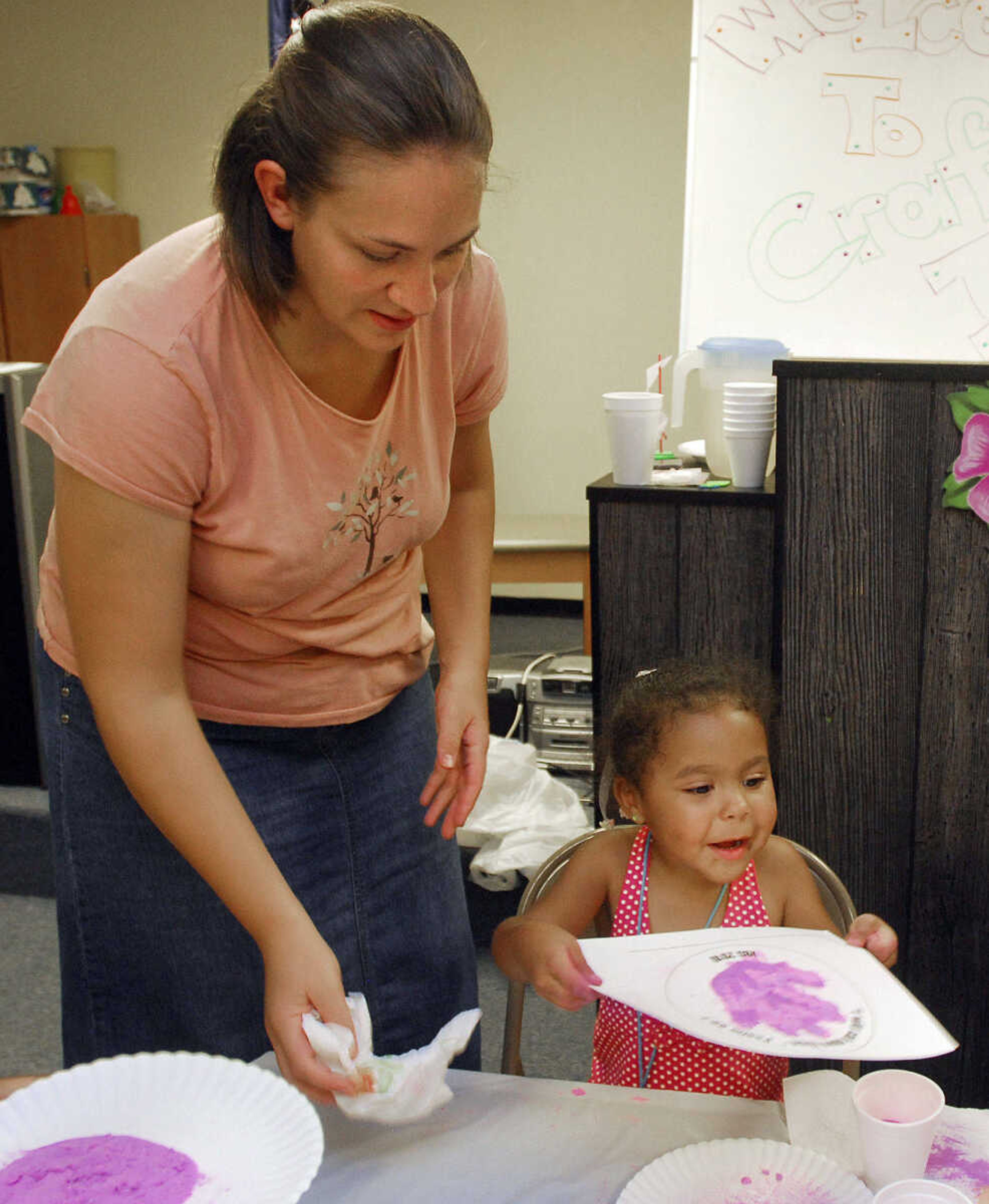 LAURA SIMON~lsimon@semissourian.com
Sara Wallace helps Bryanah Coleman with her sand hand during the arts and crafts portion of VBS at Lighthouse Bible Baptist Church in Cape Girardeau Tuesday, August 3, 2010.