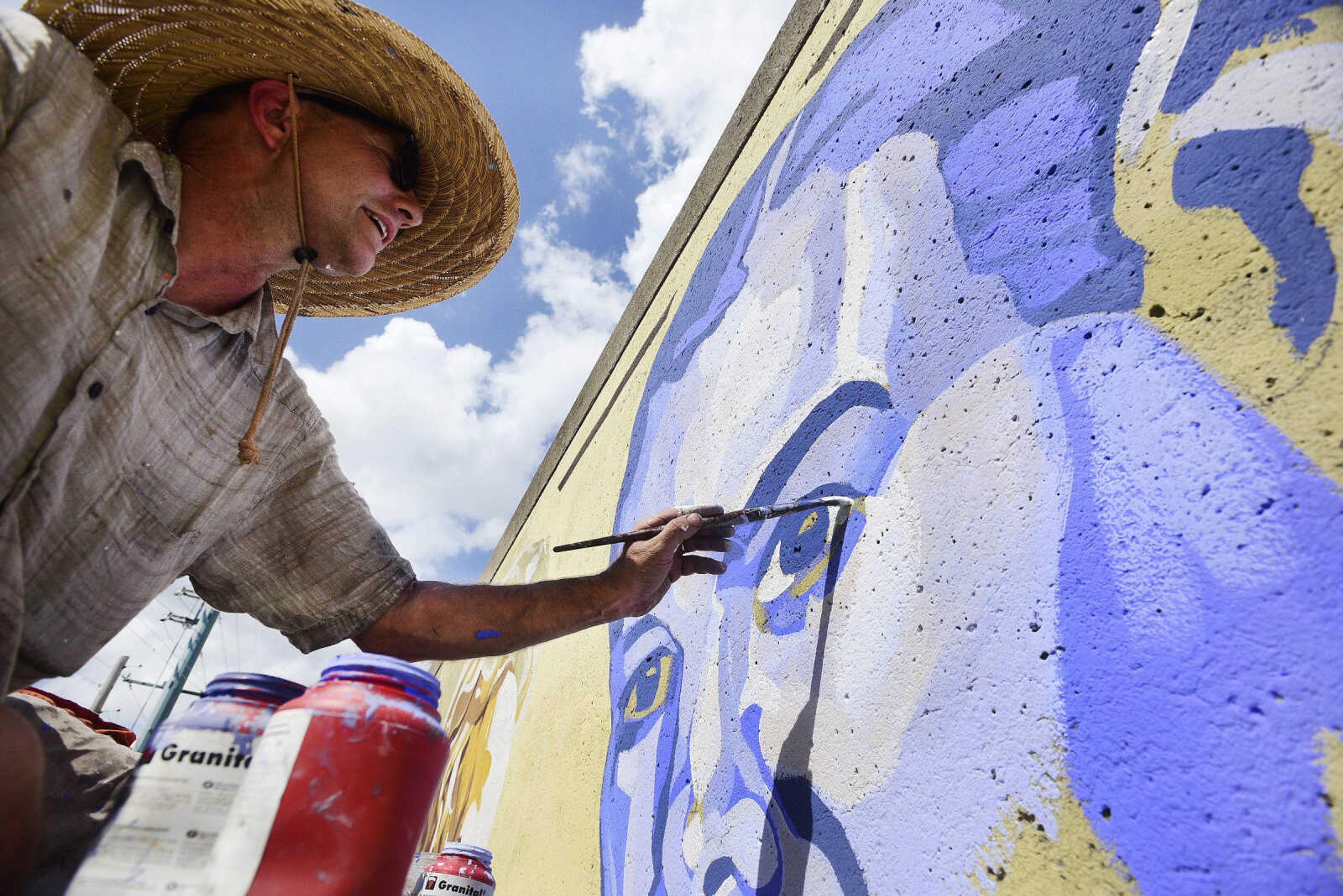 Craig Thomas paints a mural of the late Gen. Seth McKee on the Cape Girardeau downtown Wall of Fame on Thursday.