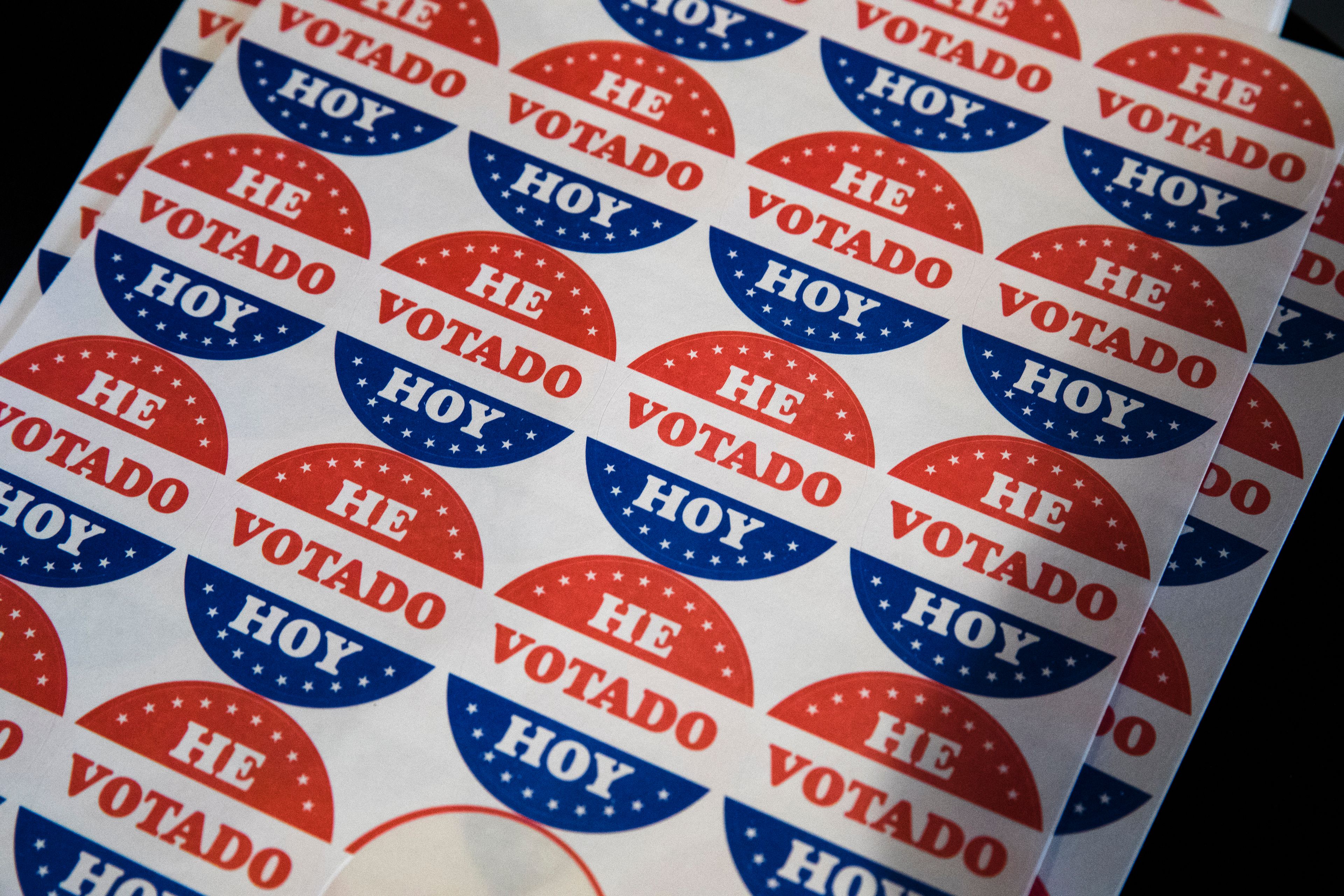 FILE - Spanish language voting stickers which read "He Votado Hoy" ("I Voted Today") are offered at a polling place in Philadelphia, May 21, 2019. (AP Photo/Matt Rourke, File)