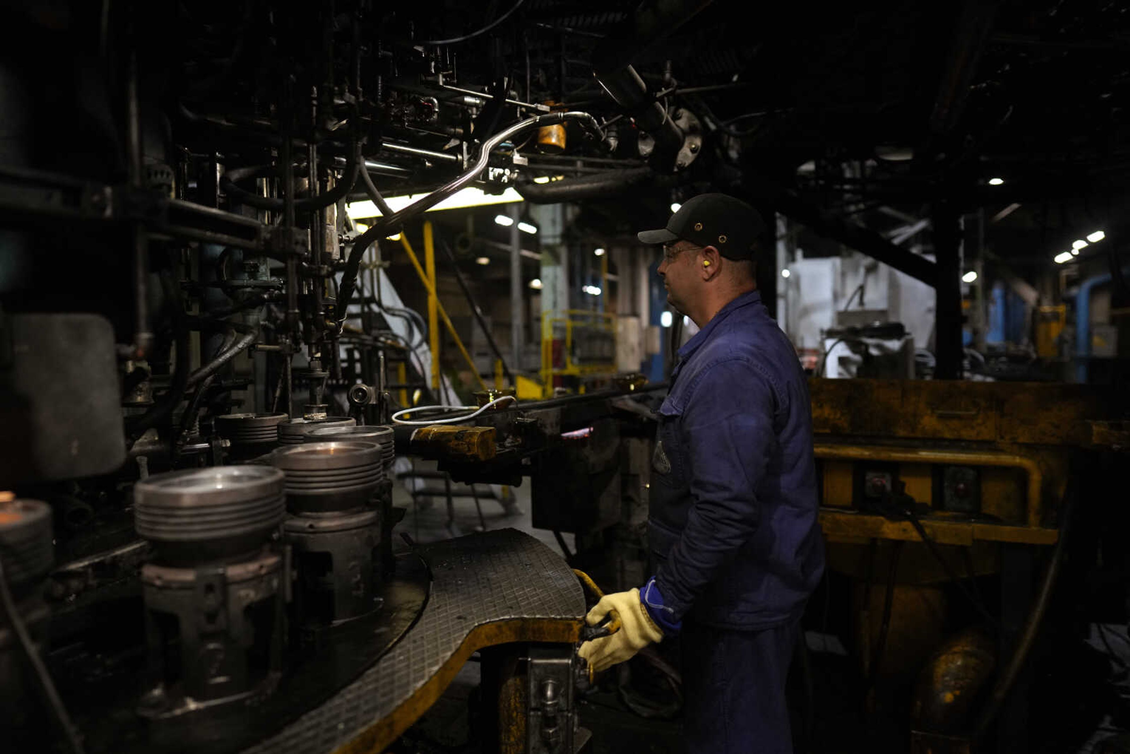 A worker inspects a machine Sept. 7 at the French glassmaker Duralex, in La Chapelle Saint-Mesmin, central France. Duralex was among European firms reducing and halting production because of soaring energy costs.