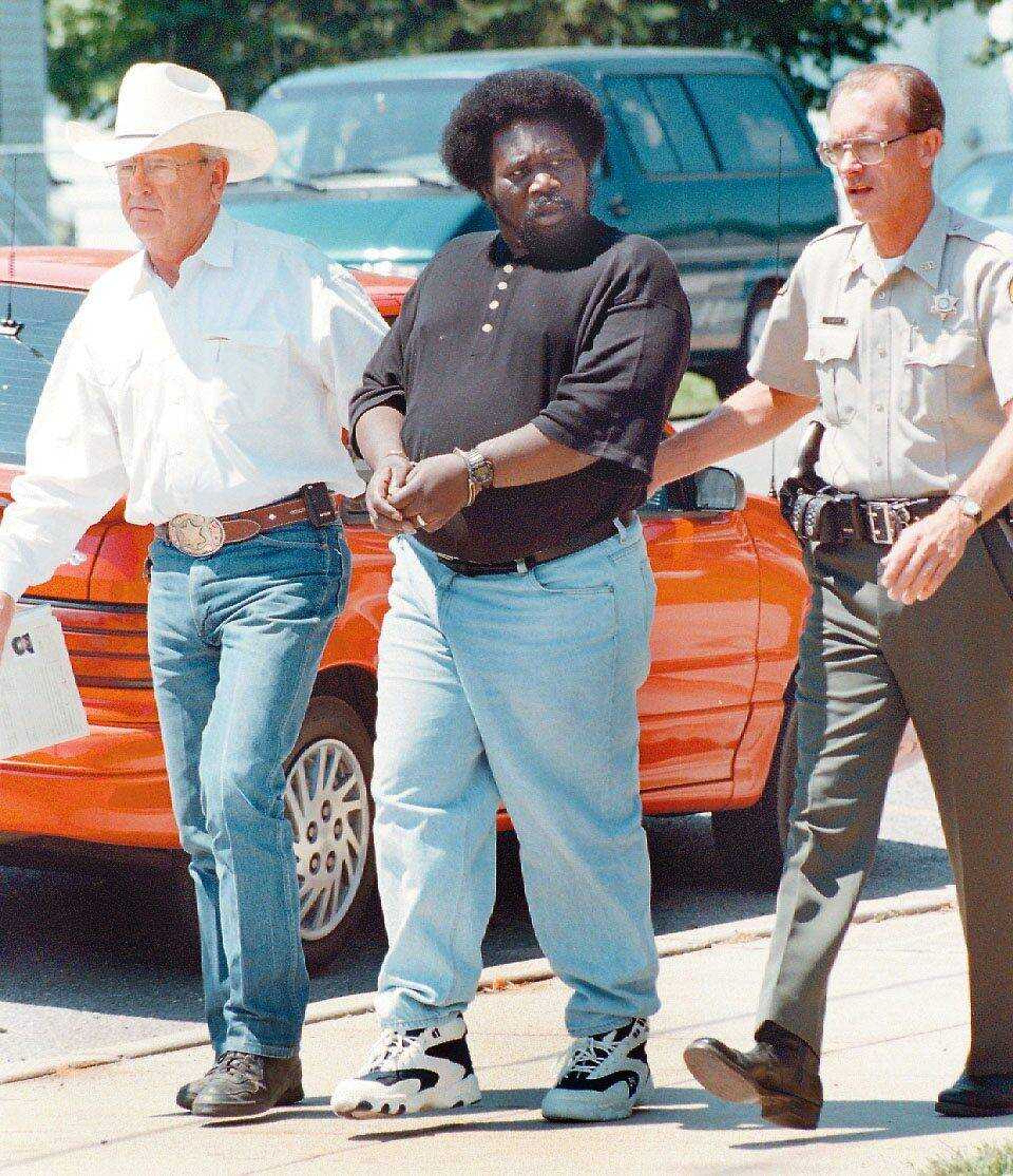 Scott County Sheriff Bill Ferrell, left, and Deputy David Ivester escorted Andrew L. Lyons back to the Scott County Jail after he was sentenced to death June 27, 1996 by Circuit Judge Anthony Heckemeyer in Benton, Mo. (Southeast Missourian file)