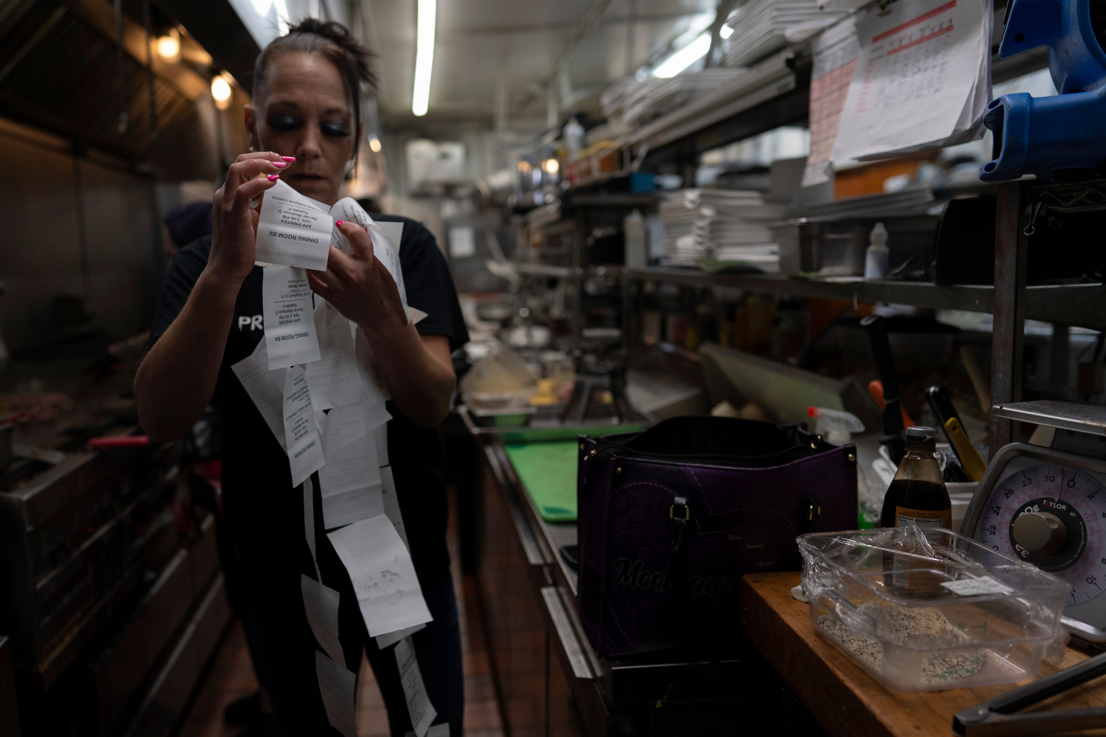 April Youst goes through dinner orders in the kitchen while working at a restaurant in West Virginia on Wednesday, Oct. 9, 2024. (AP Photo/Carolyn Kaster)