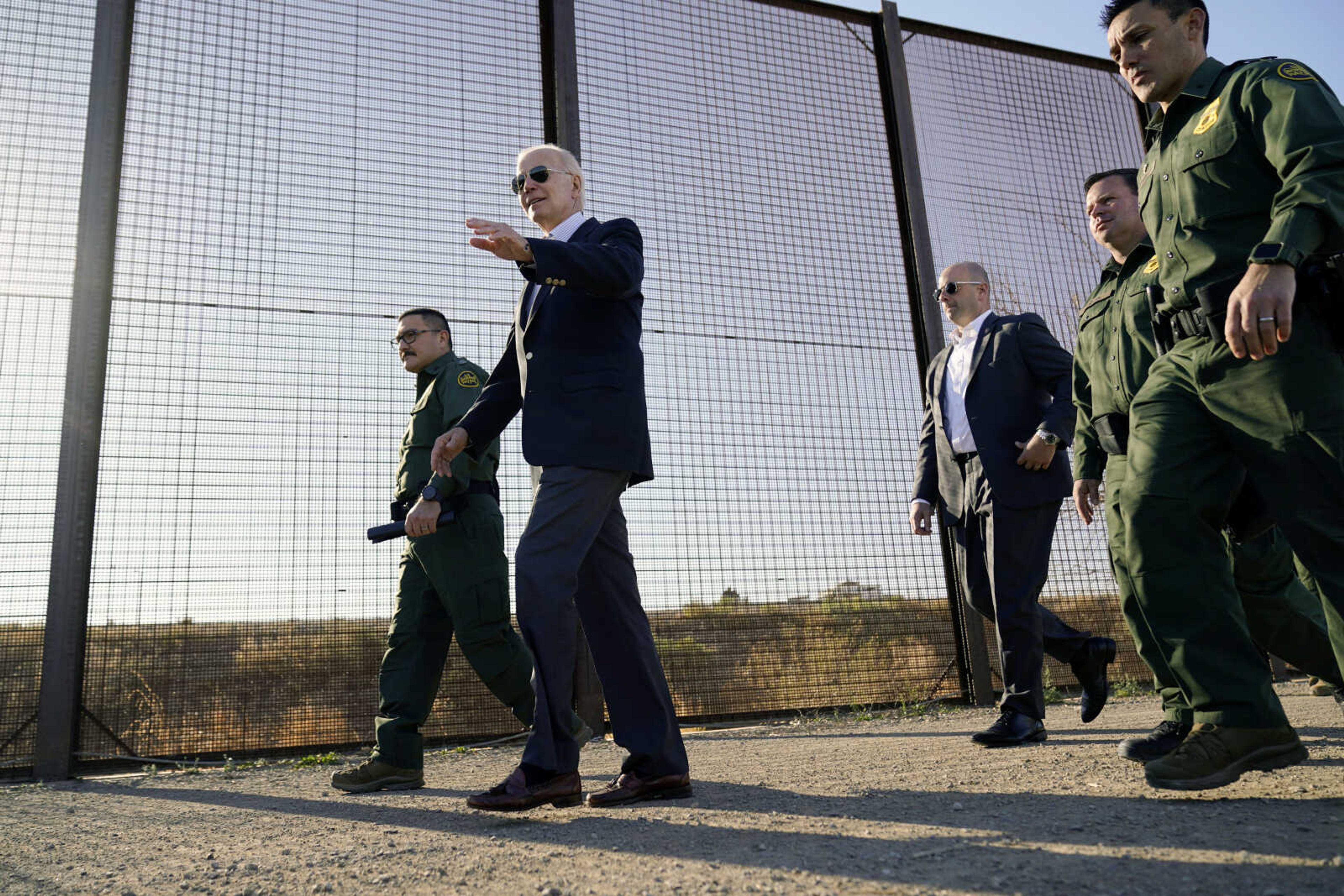 President Joe Biden walks along a stretch of the U.S.-Mexico border Jan. 8 in El Paso Texas. Military personnel will be sent to the  U.S.-Mexico border to help during an expected migrant surge next week.