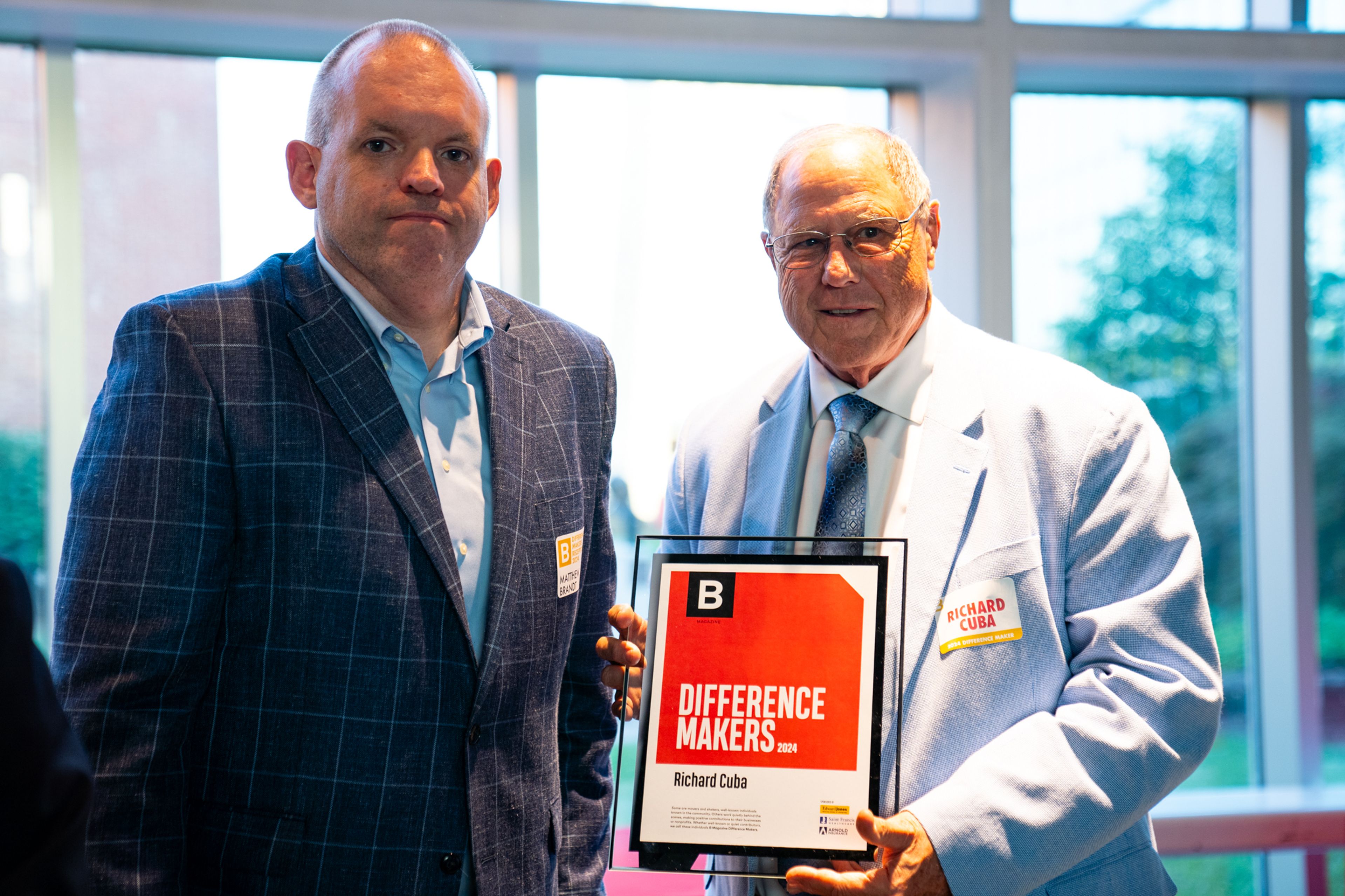 Richard Cuba receives a plaque from Saint Francis Healthcare System’s Matthew Brandt recognizing him as a 2024 Difference Maker at their reception at Southeast Missouri State University’s River Campus. The Difference Maker’s reception was presented by B Magazine on Thursday, Sept. 6.