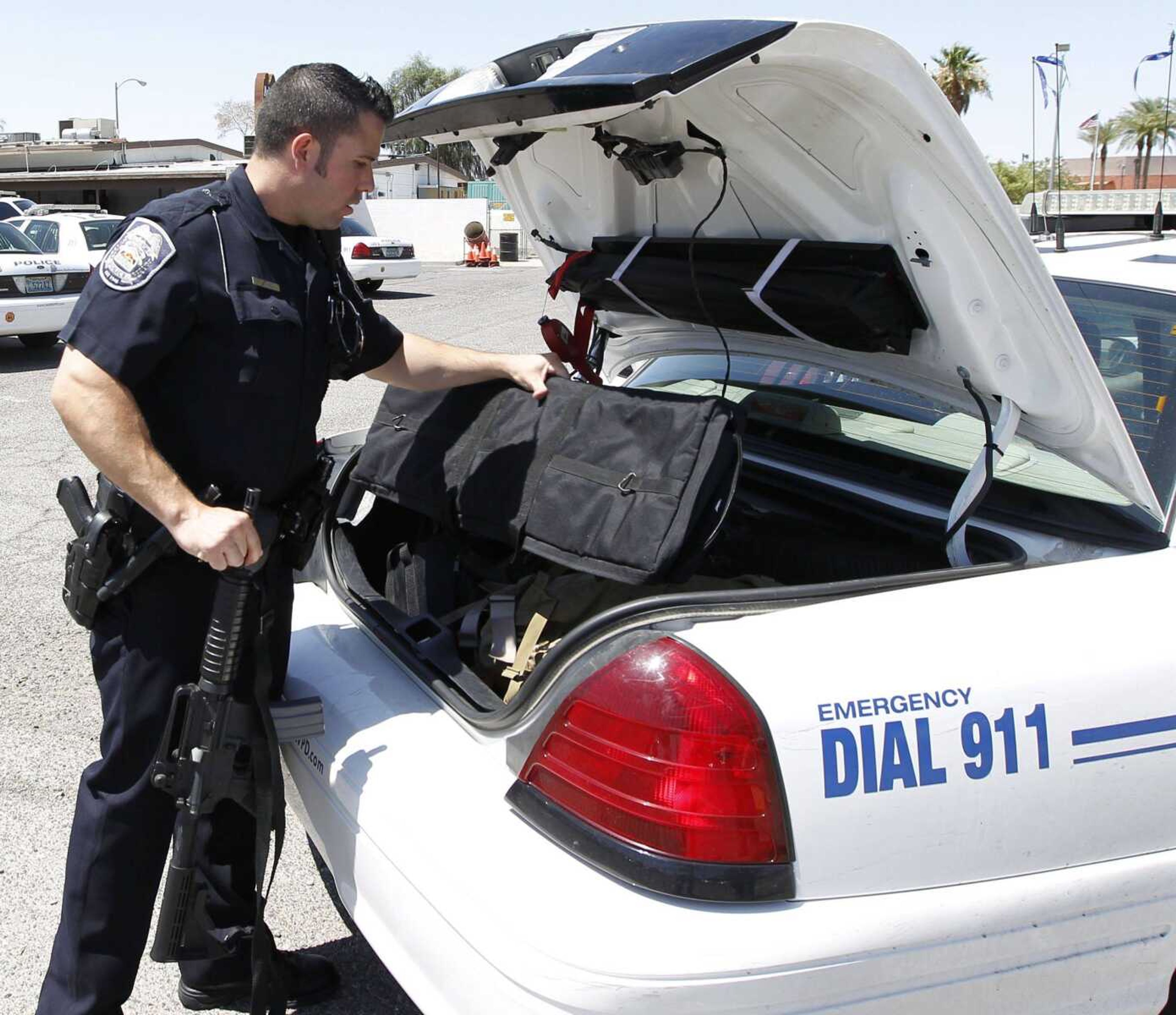 Police officer Joe Minelli loads his patrol cruiser at the start of his swing shift July 13 in North Las Vegas, Nev. In North Las Vegas, the hardest-hit city in the hardest-hit state in the nation, even the police officers have lost hope. (Duane Prokop ~ Las Vegas Review-Journal)