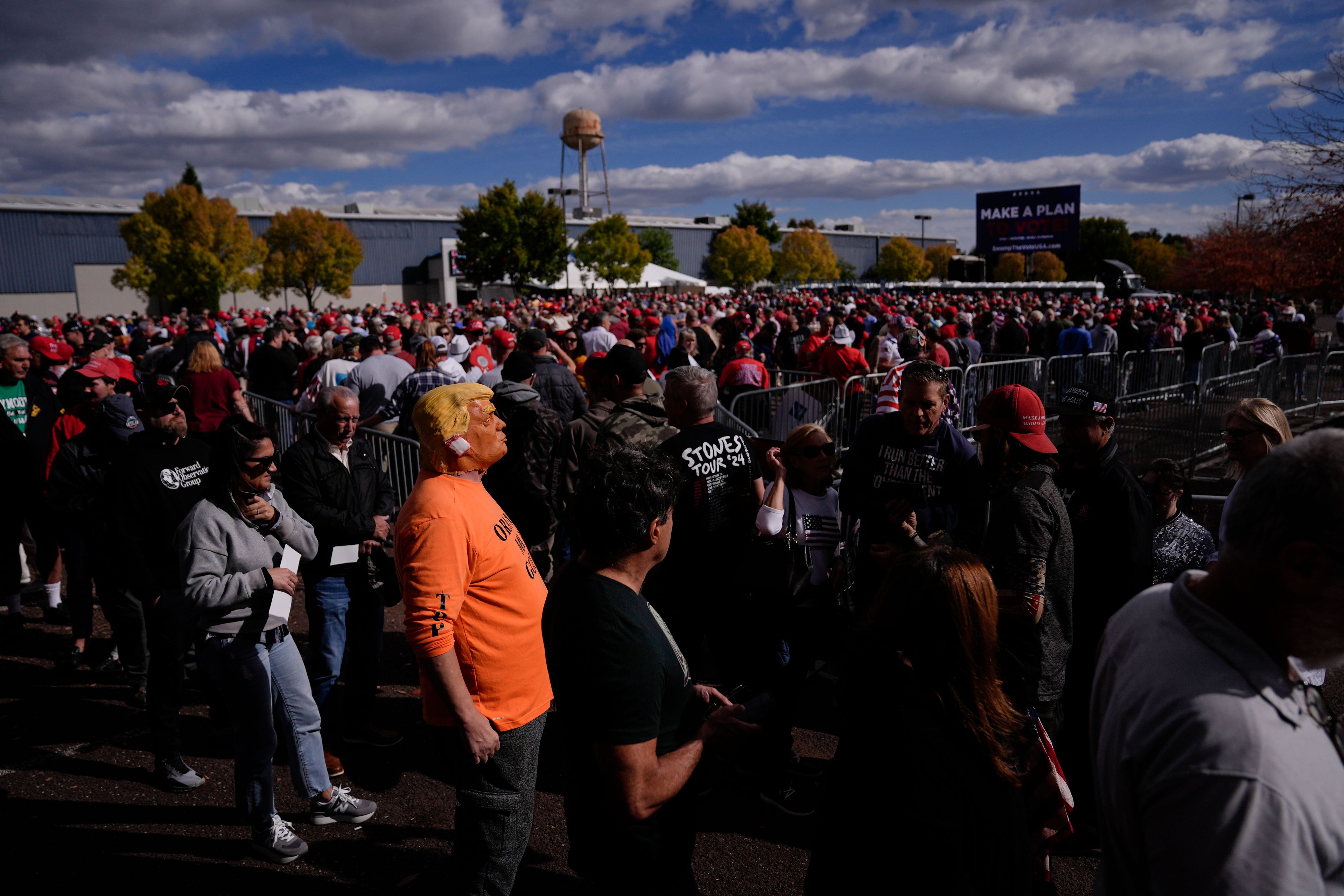 People wait in line to attend a Republican presidential nominee former President Donald Trump campaign town hall, Monday, Oct. 14, 2024, in Oaks, Pa. (AP Photo/Matt Rourke)