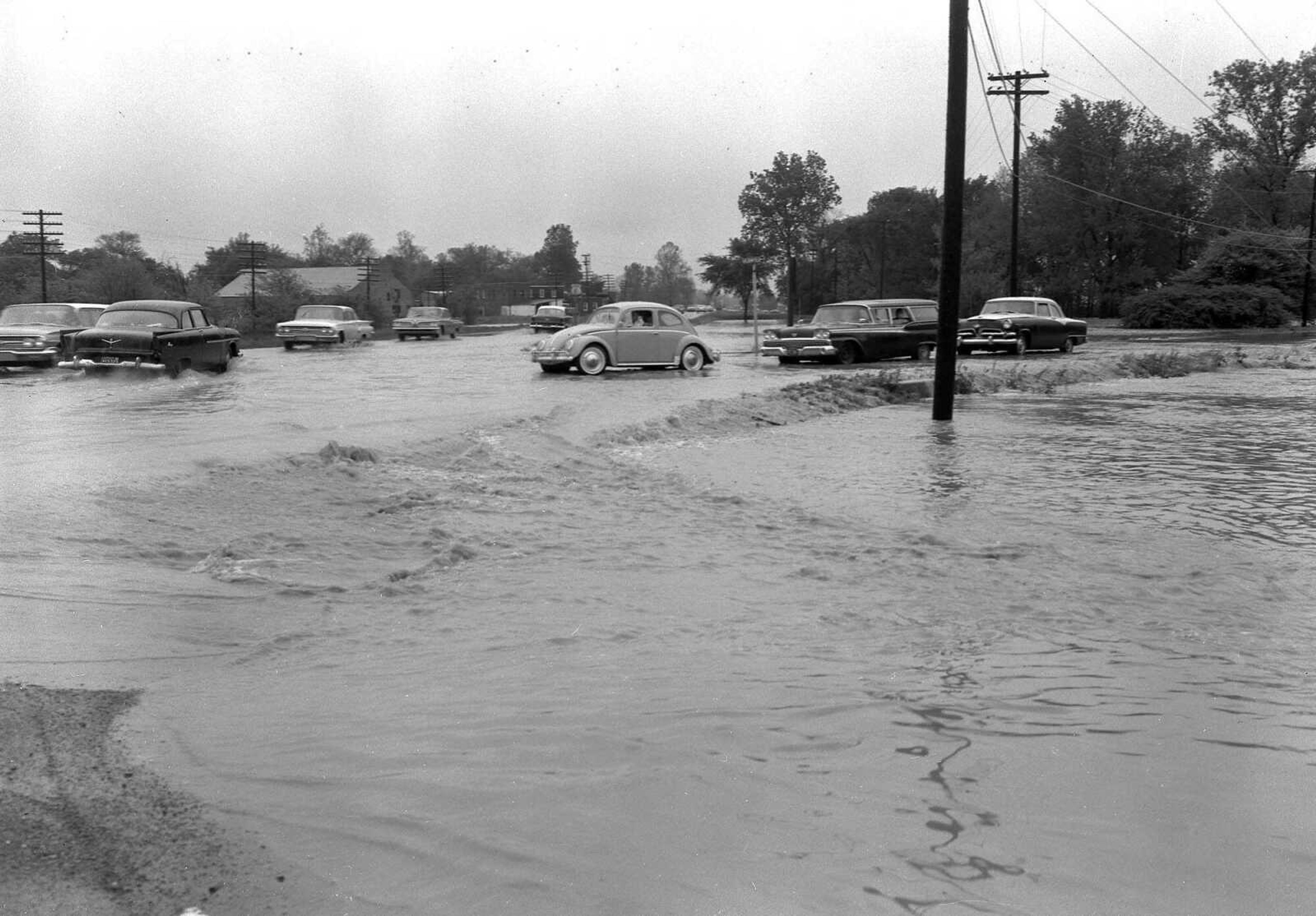 May 8, 1961 Southeast Missourian.
As in the past, Cape LaCroix Creek couldn't carry all the water during the heavy, continuous rain this weekend. This picture was made Sunday morning after Saturday night's downpour, showing water over the intersection of Highway 61 and Bloomfield Road. (G.D. Fronabarger/Southeast Missourian archive)