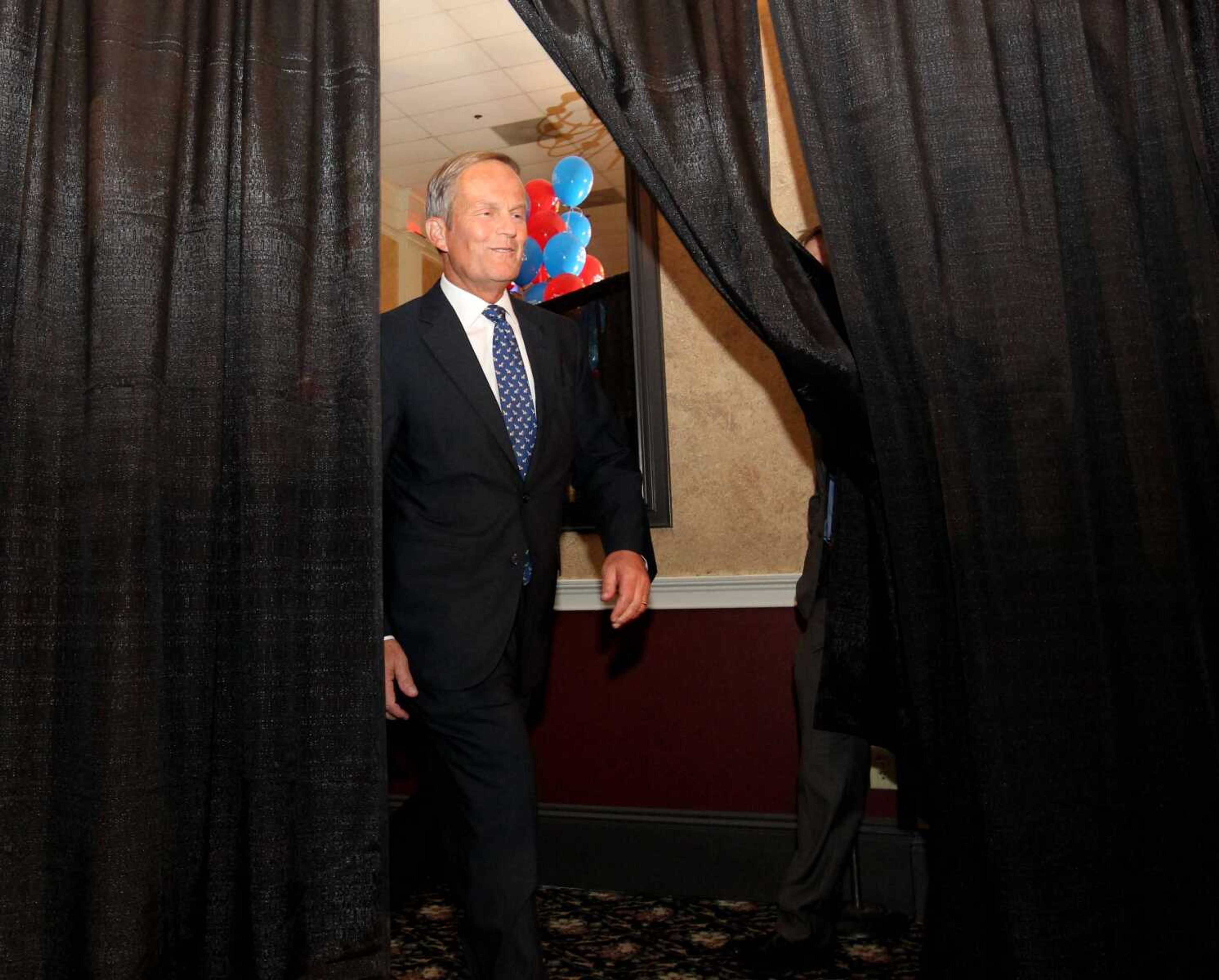 Republican U.S. Senate candidate Todd Akin emerges to give his victory speech after his win in the senate primary race at his campaign party at the Columns Banquet Center in St. Charles, Mo., on Tuesday, Aug. 7, 2012. (AP Photo/St. Louis Post-Dispatch, Christian Gooden)