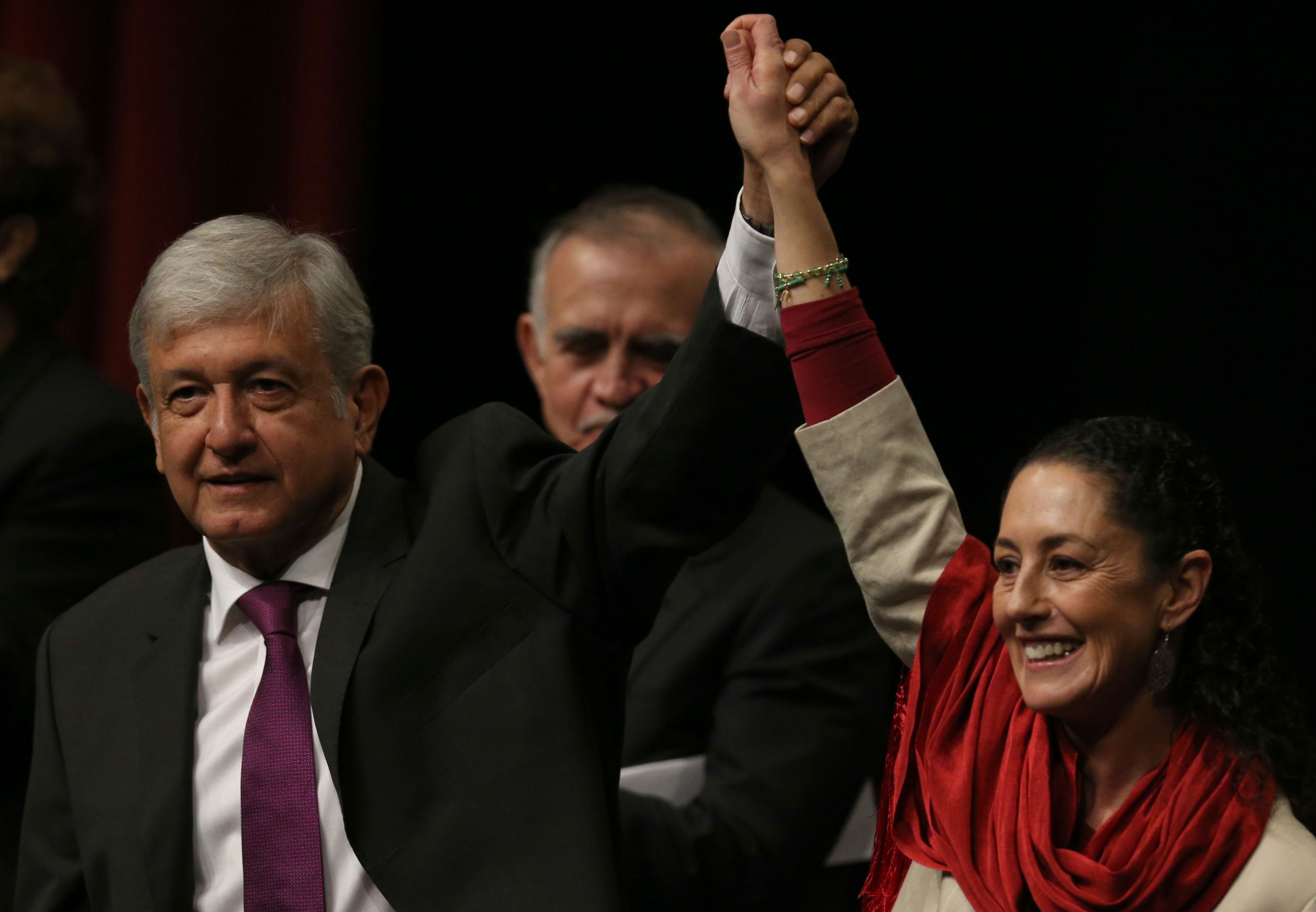 FILE - Presidential hopeful Andres Manuel Lopez Obrador, left, and Claudia Sheinbaum, coordinator of the Morena political party, hold hands at an event at the National Auditorium in Mexico City, Nov. 20, 2017. (AP Photo/Marco Ugarte, File)