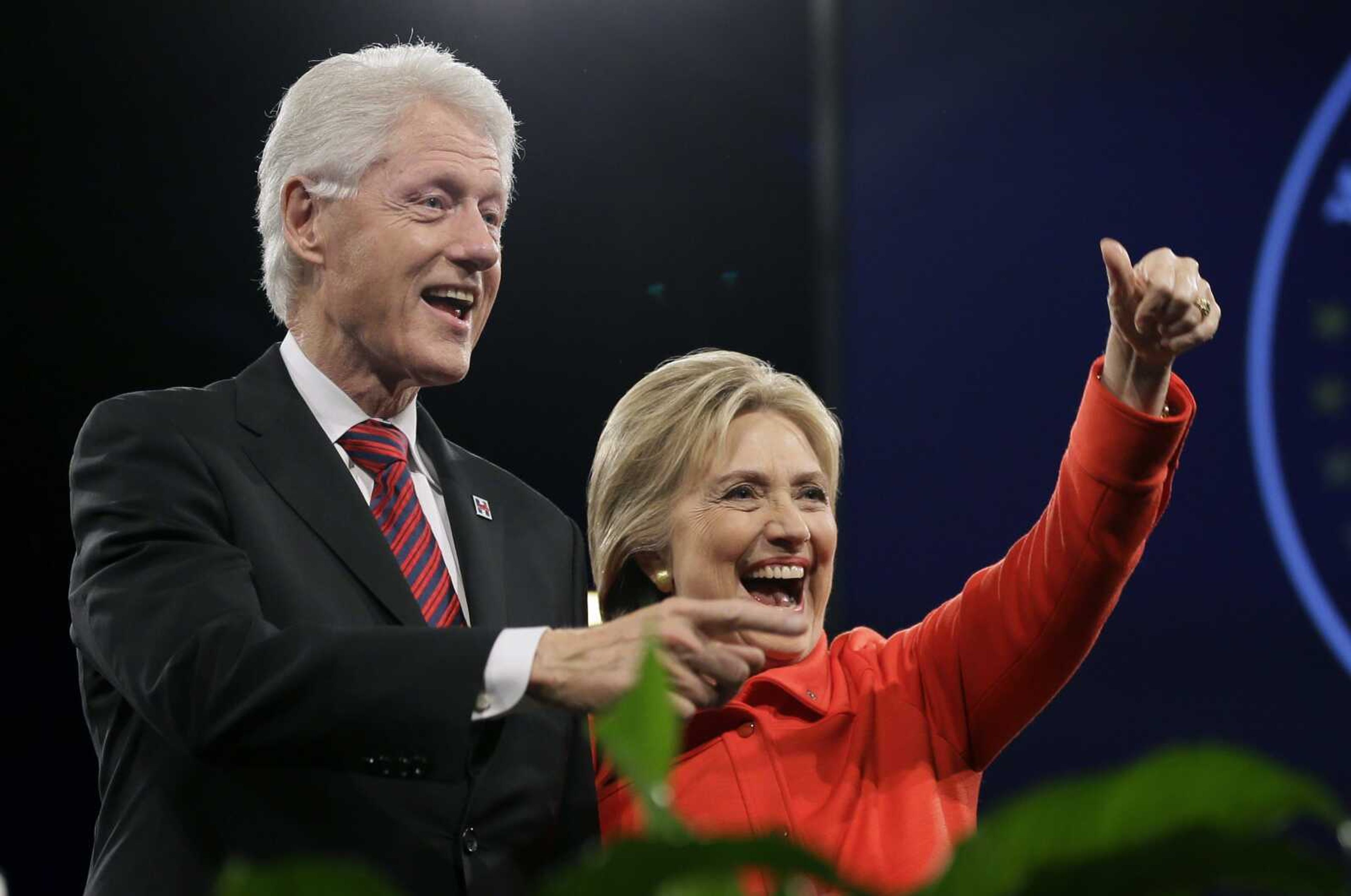 Former president Bill Clinton and his wife, Democratic presidential candidate Hillary Rodham Clinton, wave to supporters after the Iowa Democratic Party's Jefferson-Jackson fundraising dinner Oct. 24 in Des Moines, Iowa. (Charlie Neibergall ~ Associated Press)