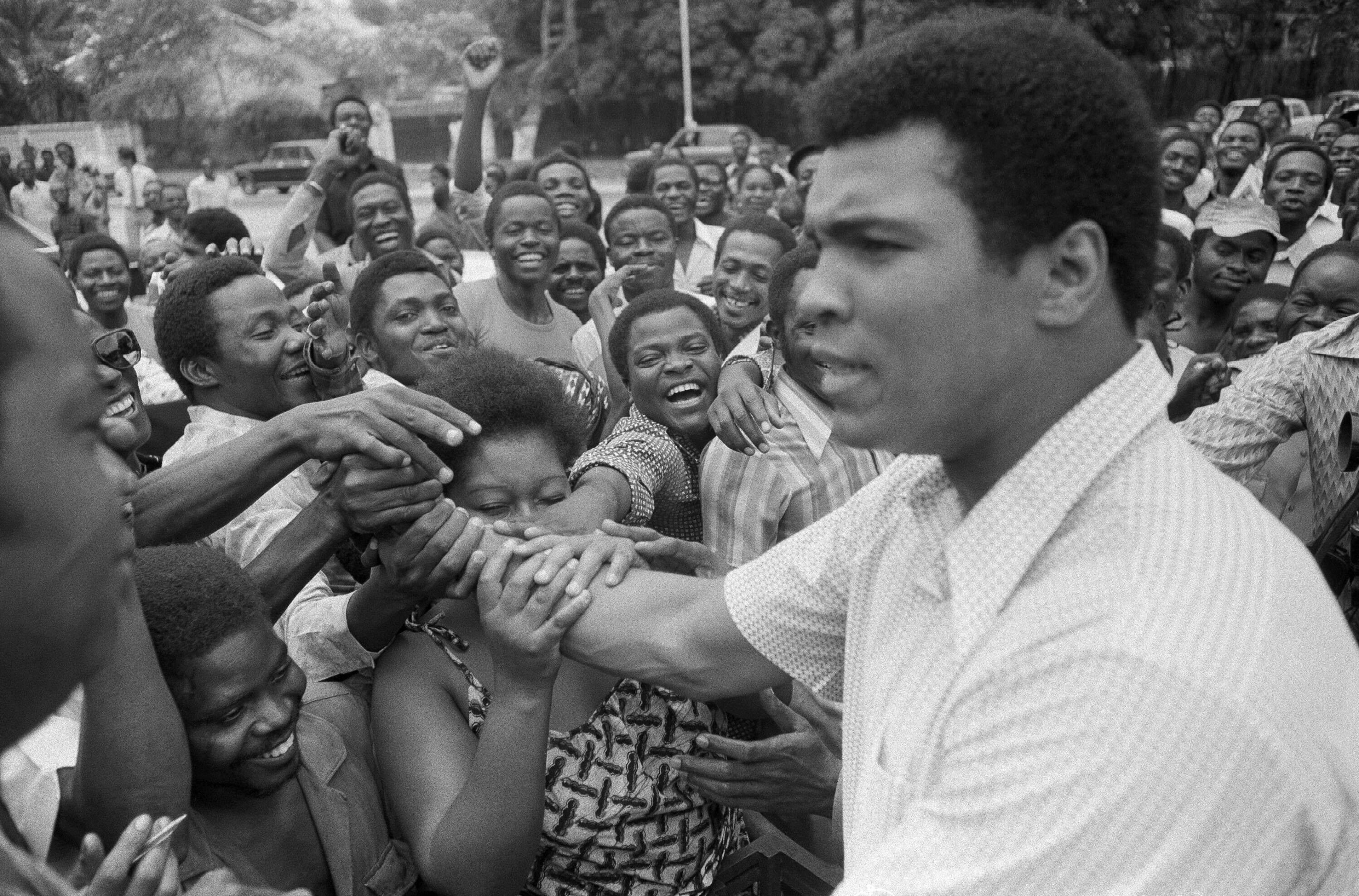 FILE - Muhammad Ali is greeted in downtown Kinshasa, Zaire on Sept. 17, 1974. (AP Photo)