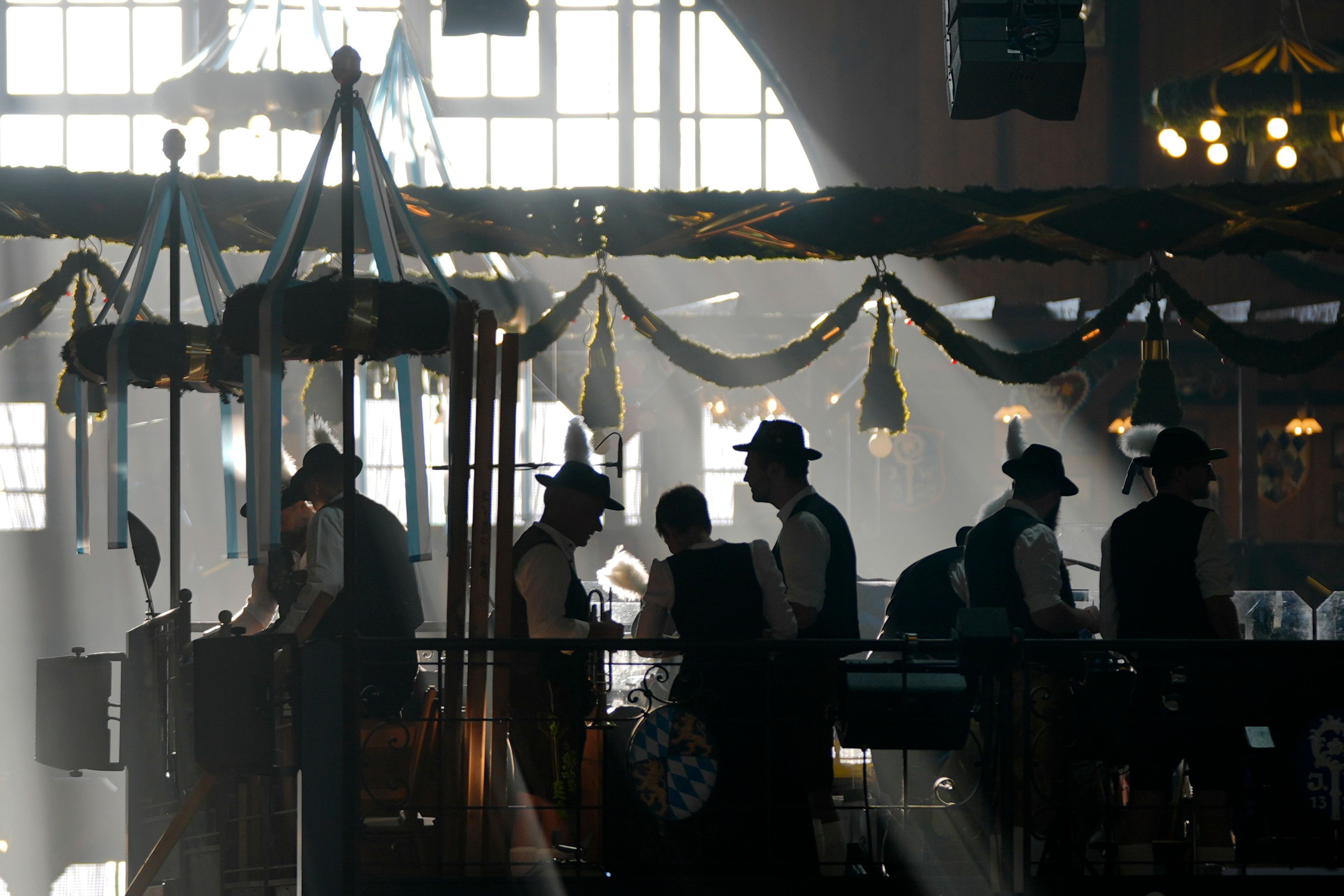 Bavarian musicians prepare in the Augustiner marquee for the start of the 189th 'Oktoberfest' beer festival in Munich, Germany, Saturday morning, Sept. 21, 2024. (AP Photo/Matthias Schrader)