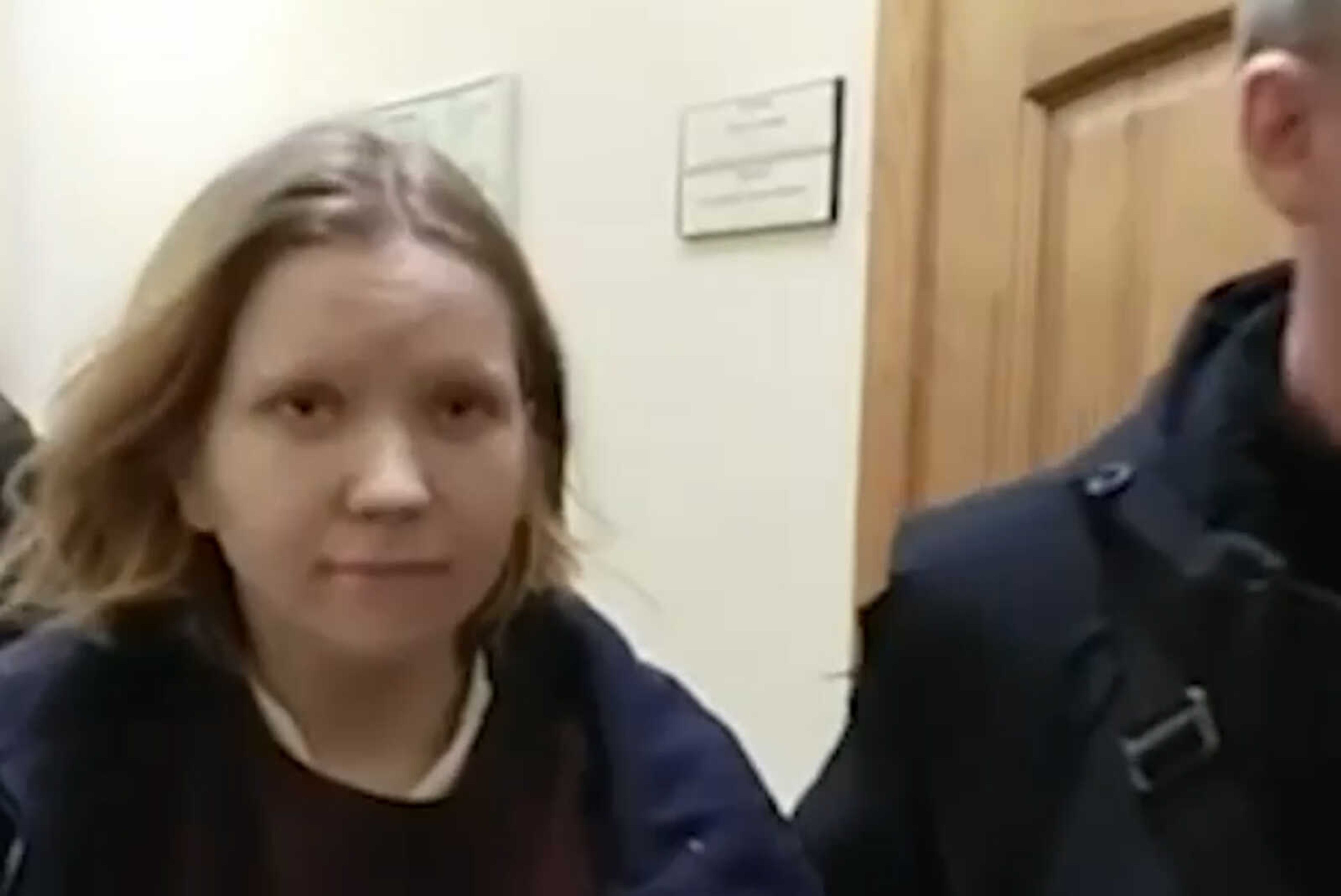 This image taken from video released by the Russian Investigative Committee on Monday, April 3, 2023, shows Darya Trepova, a 26-year-old St. Petersburg resident suspected of involvement in a bombing at a St. Petersburg cafe walking escorted by officers. Anti-Terrorist Committee said Monday that the attack on Vladlen Tatarsky was  planned by Ukrainian special services.  Russia's Investigative Committee reported the arrest of Darya Trepova, a St. Petersburg resident suspected of involvement in the attack. (Russian Investigative Committee via AP)